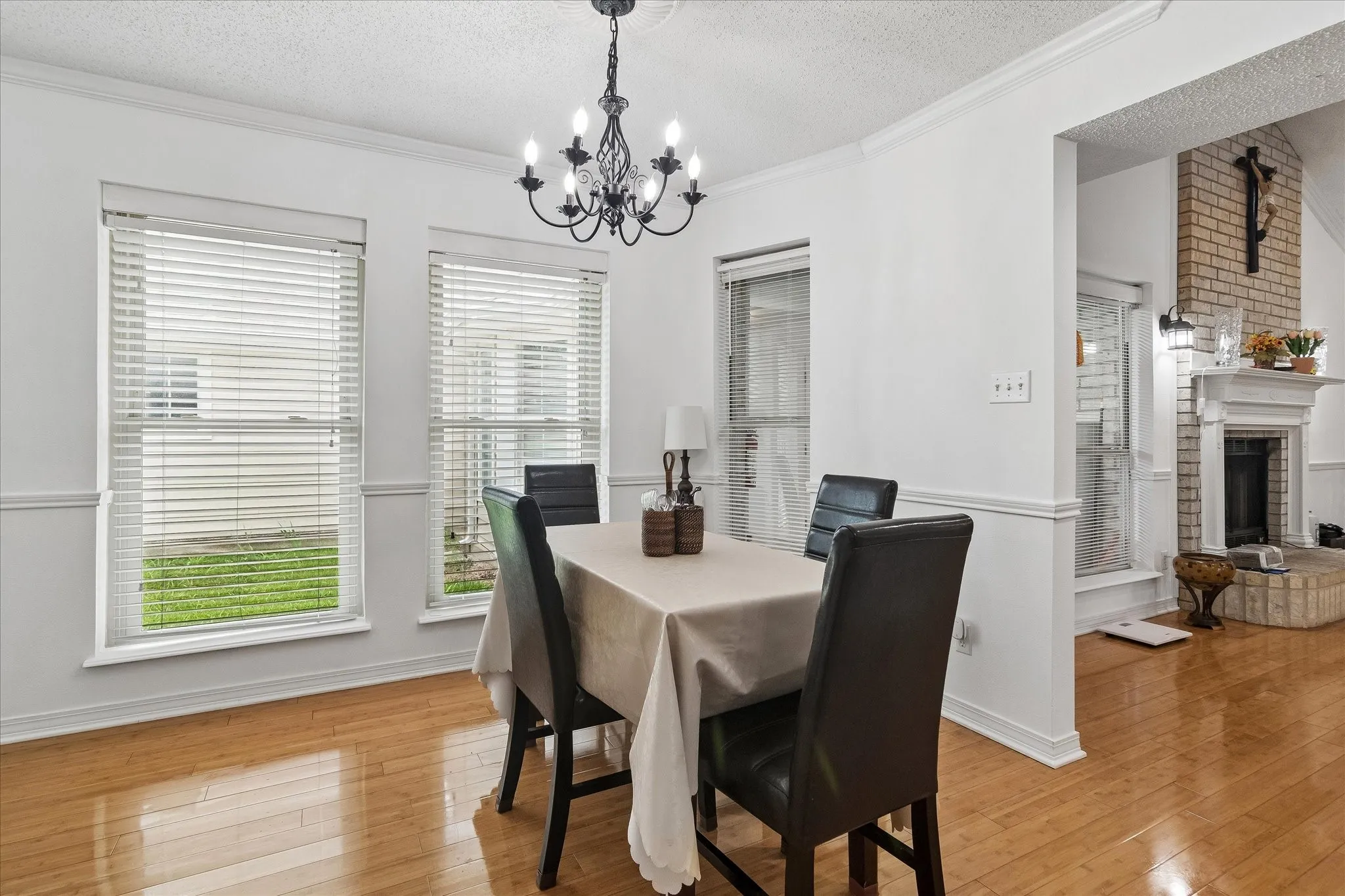 Dining area featuring wood-finish flooring and crown molding