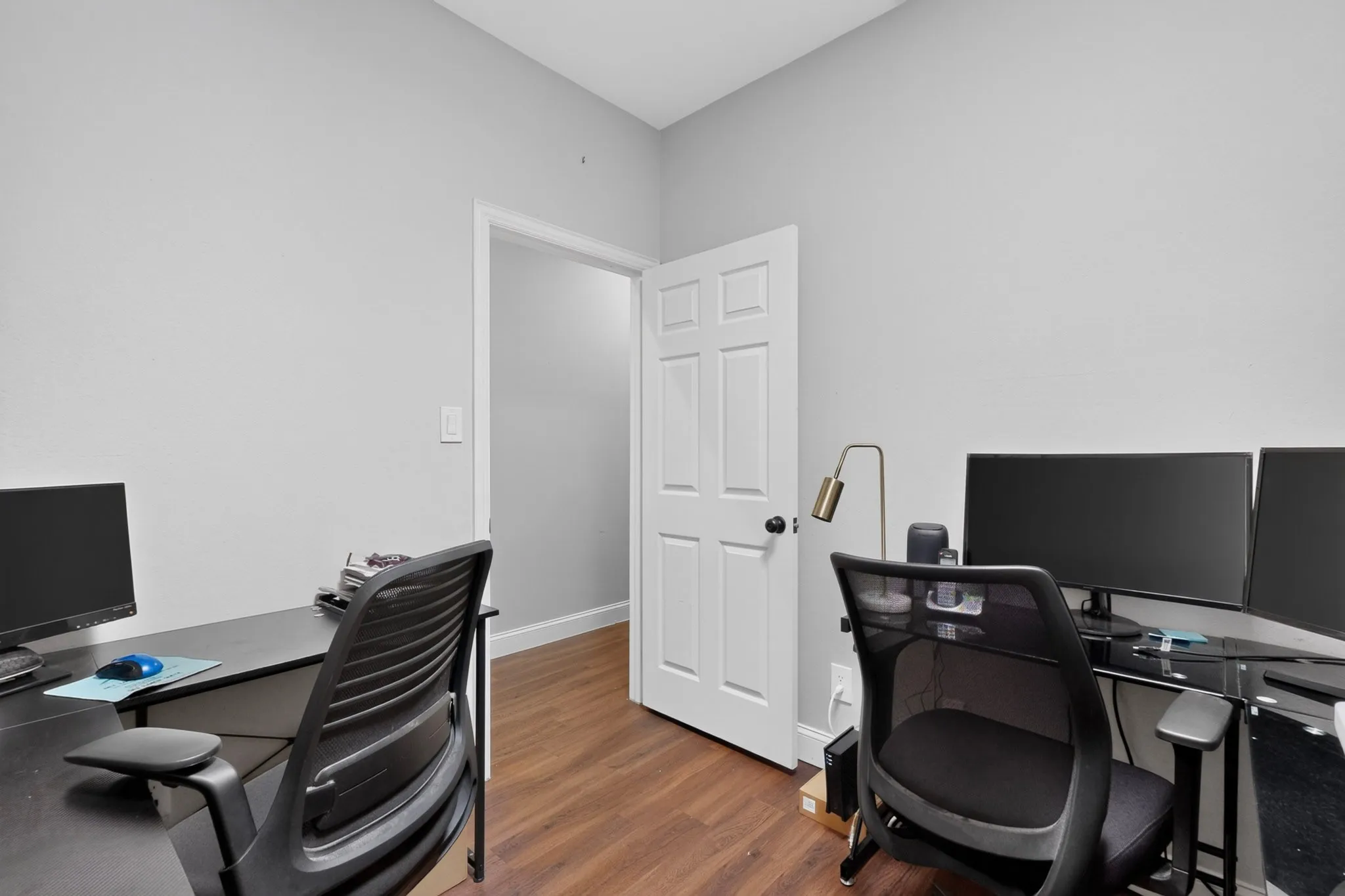 Room with neutral tone walls and wood-finish flooring