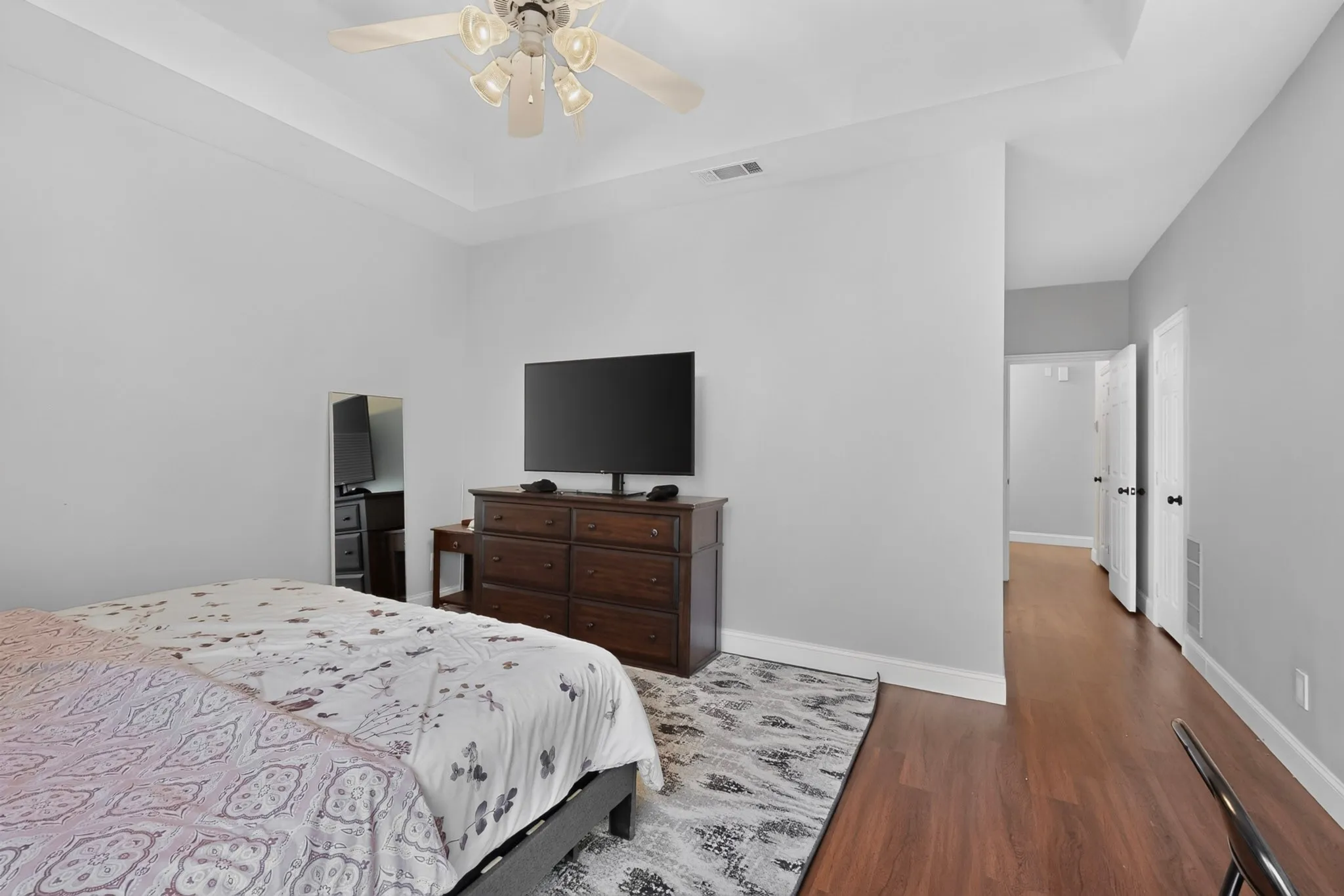 Tray ceiling featuring a ceiling fan with integrated lighting