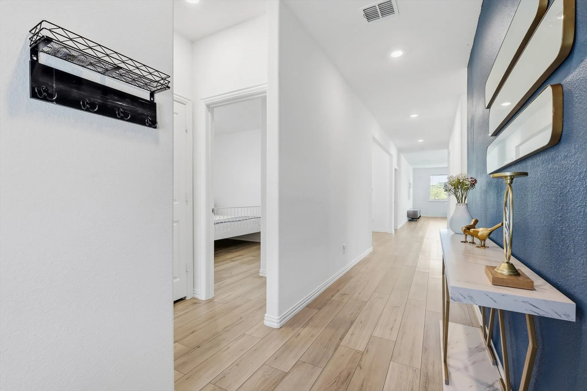 Entry hallway with bedrooms 2 and 3 plus linen closet and full bath to the left