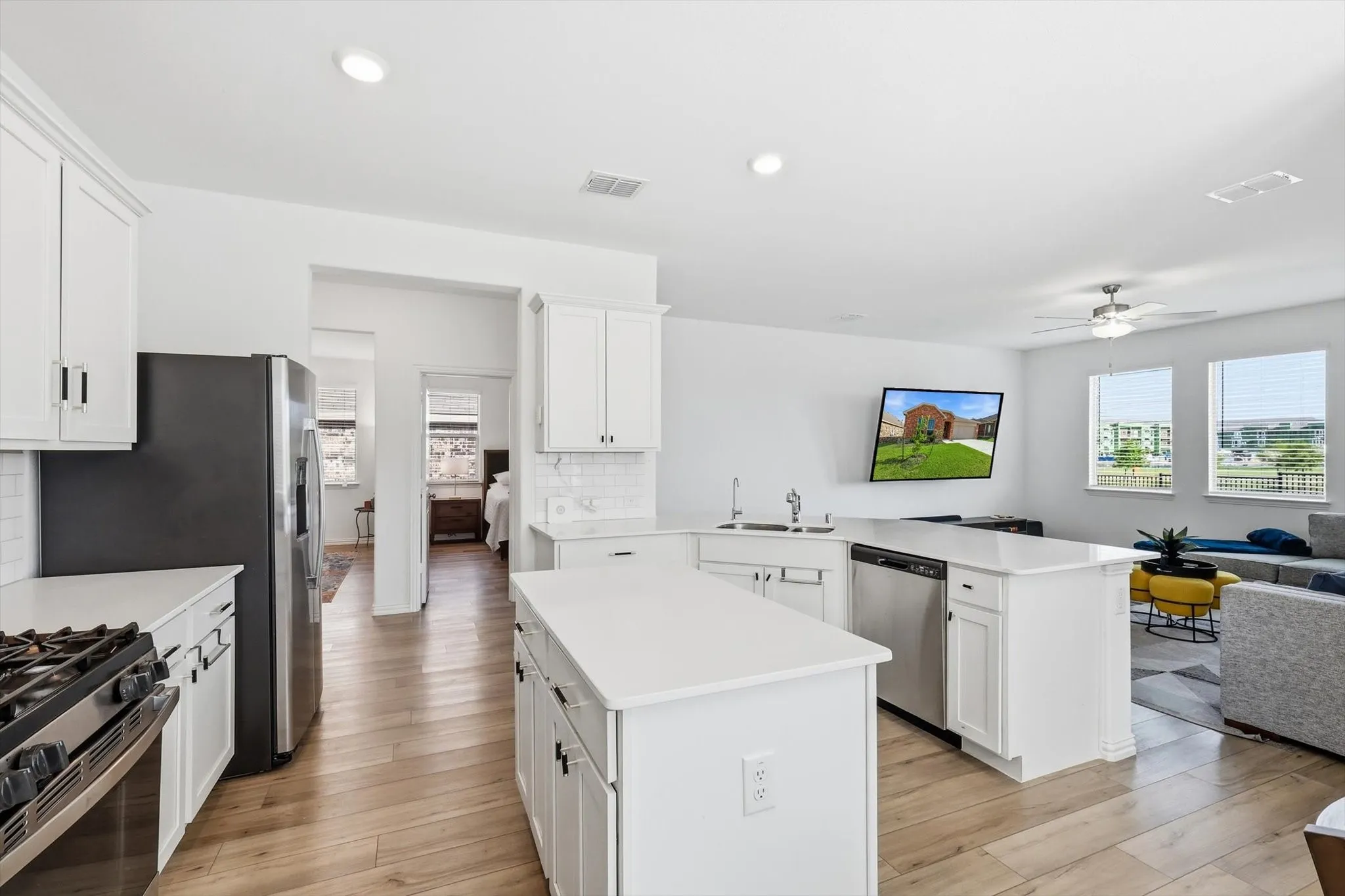 With southern light streaming in, the white kitchen is a welcoming place to prepare food.
