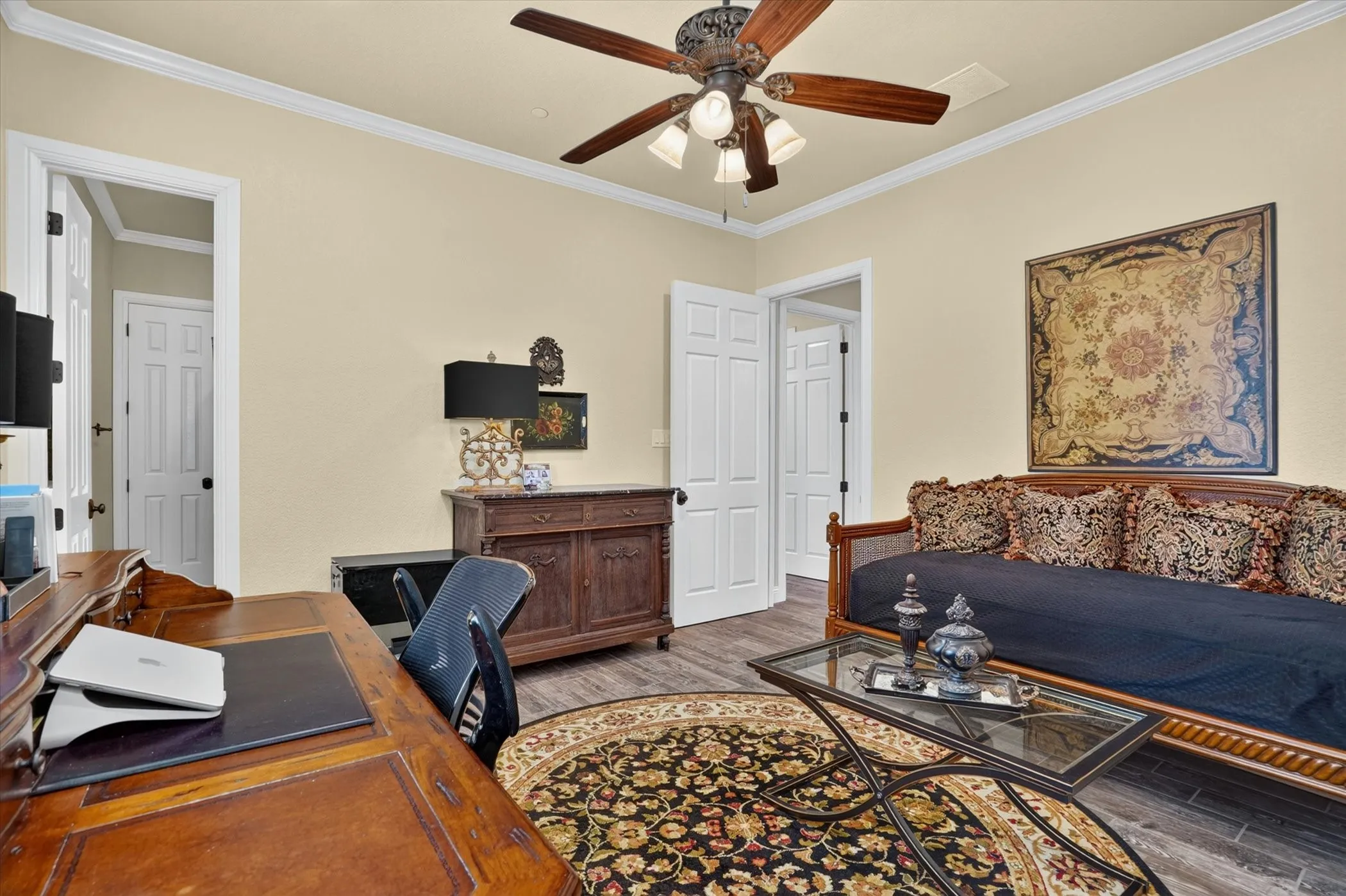 Interior room featuring crown molding, neutral wall color, and wood-finish flooring
