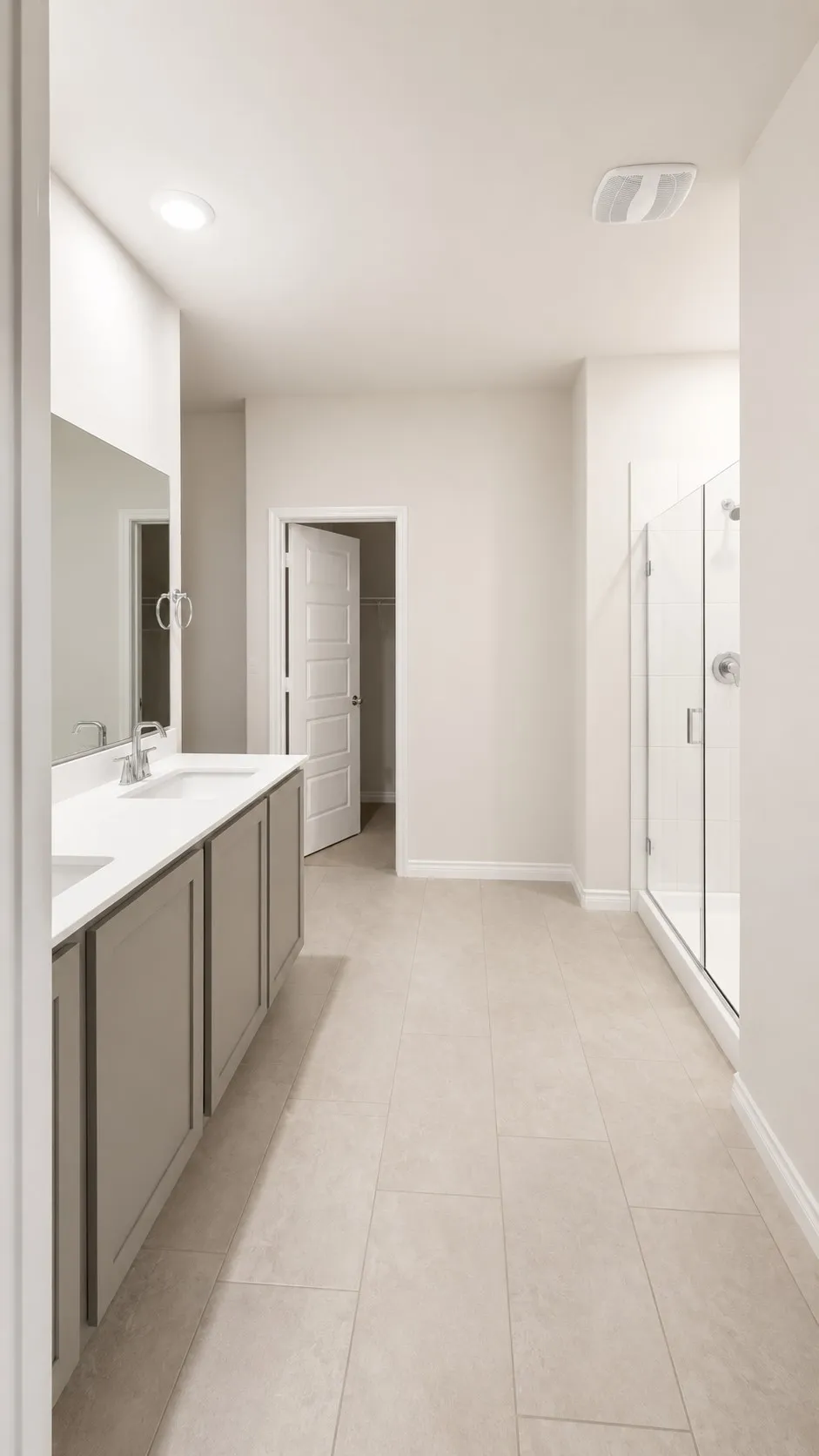Dual sink vanity with light gray cabinetry and white countertops