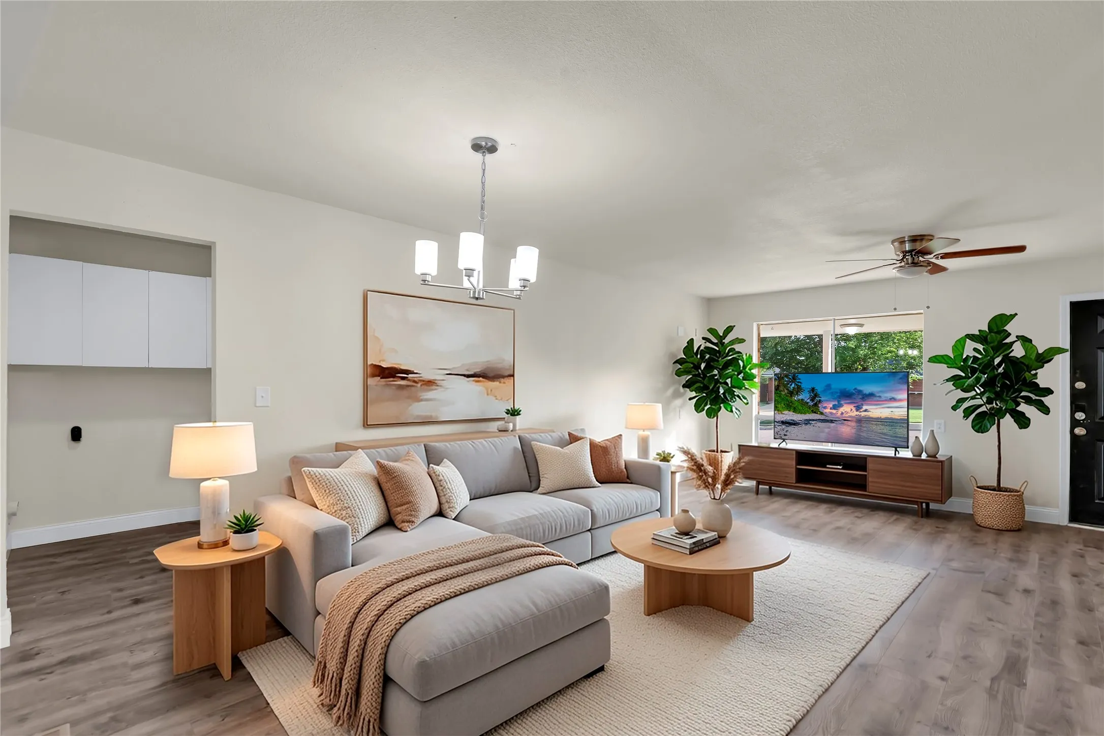 Spacious living area featuring wood-finish flooring, a contemporary chandelier, and recessed lighting