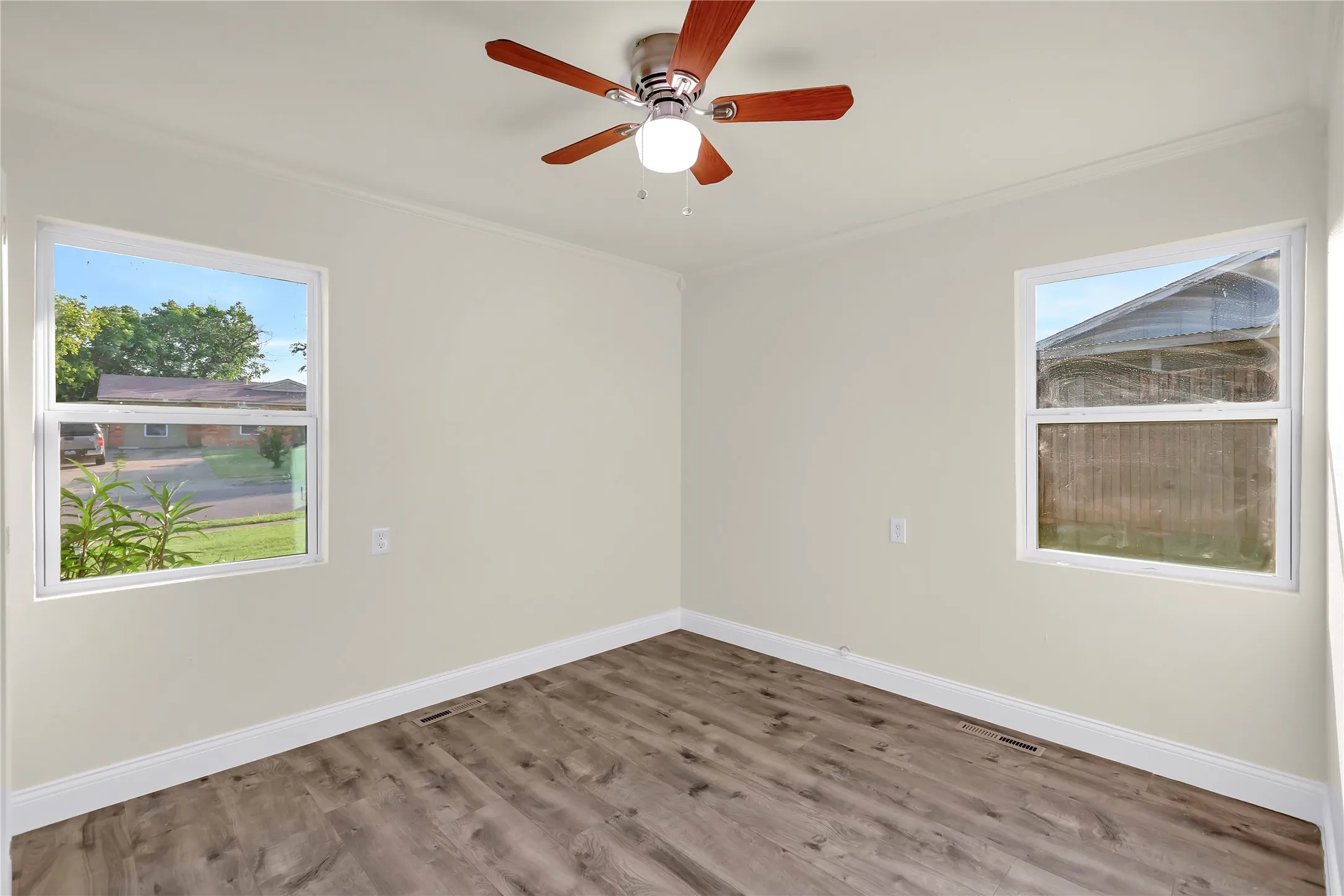 Bright interior space featuring wood-finish flooring, light-toned walls, and white trim