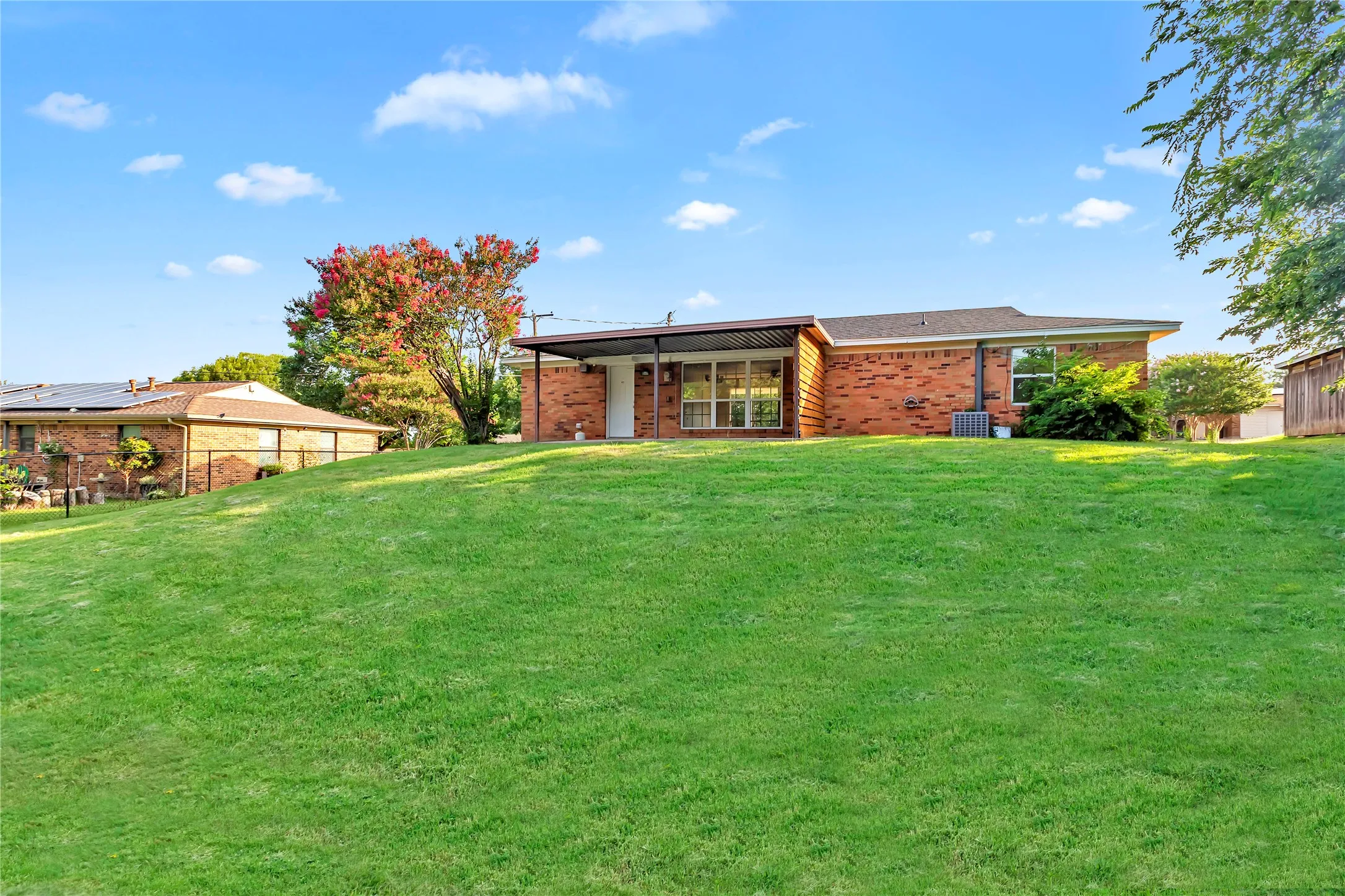 Expansive rear yard with a verdant lawn