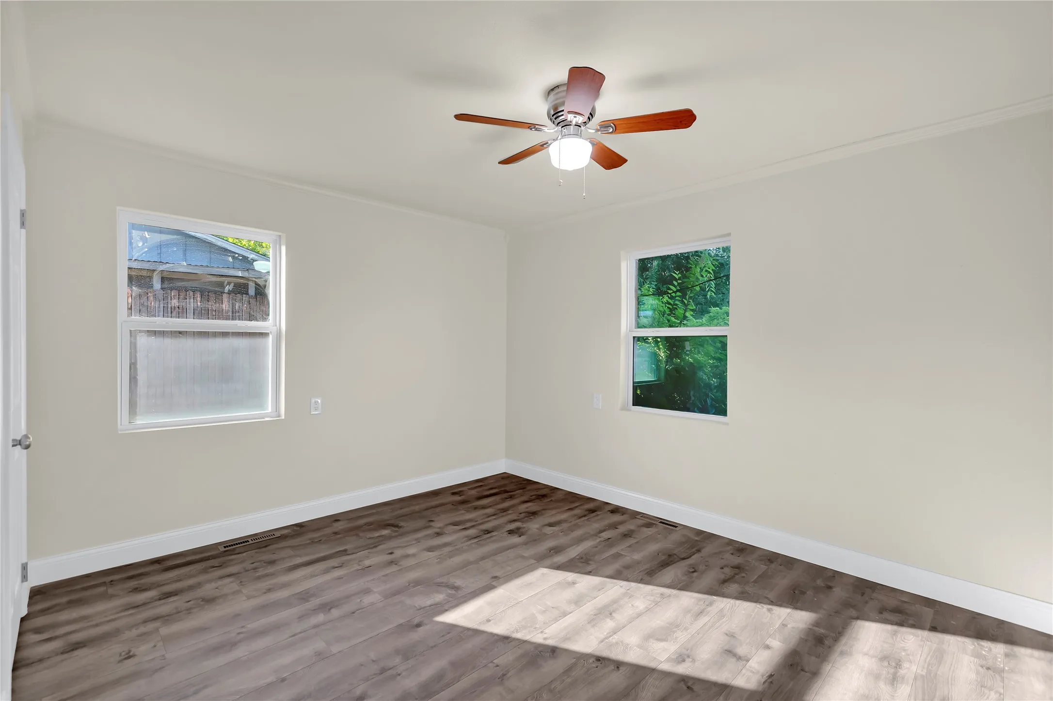 Neutral wall tones with wood-finish flooring