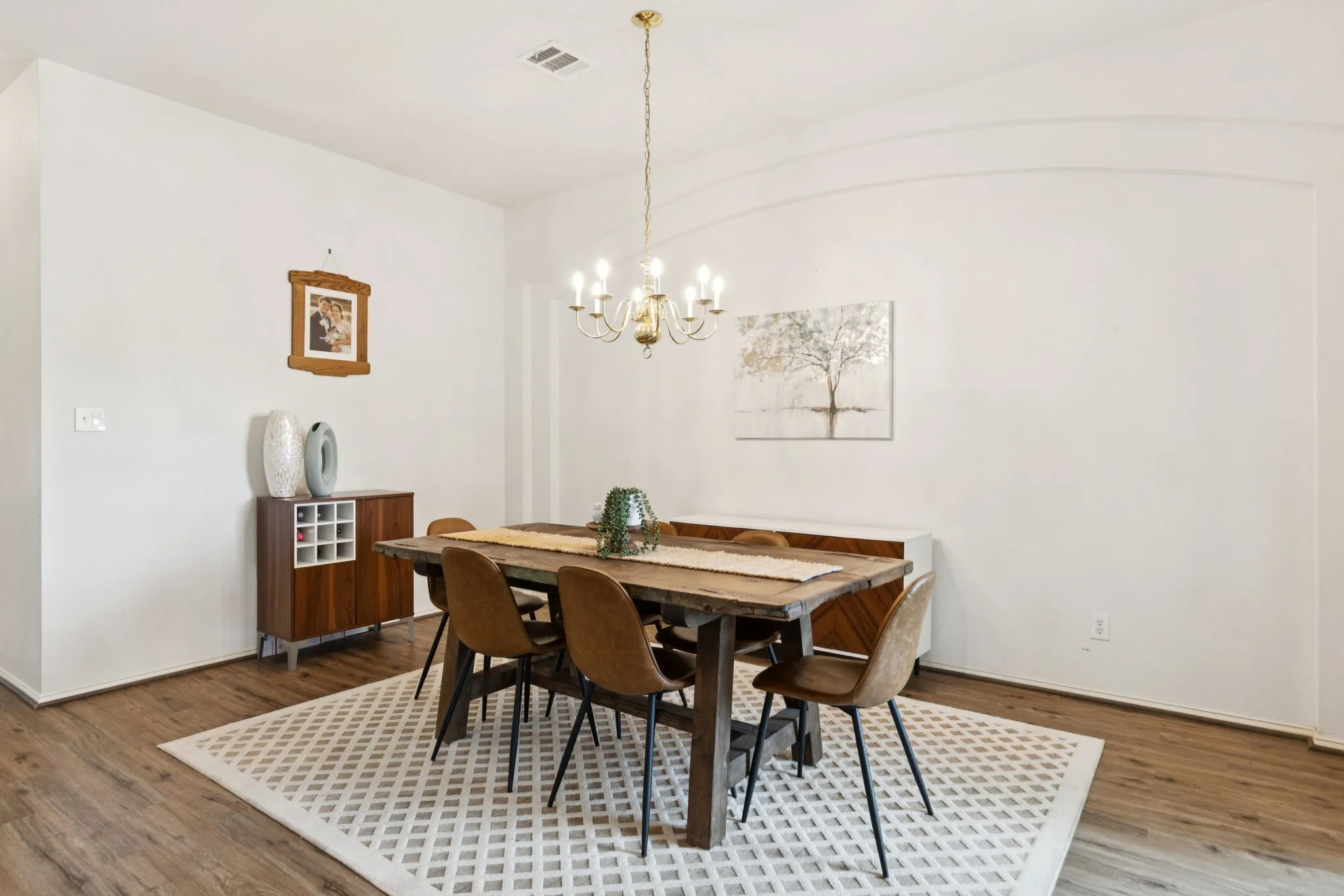 The dining room offers room for an oversized dining table, perfect for gathering friends and family for a meal. The room enjoys an arched accent wall as well as laminate flooring.