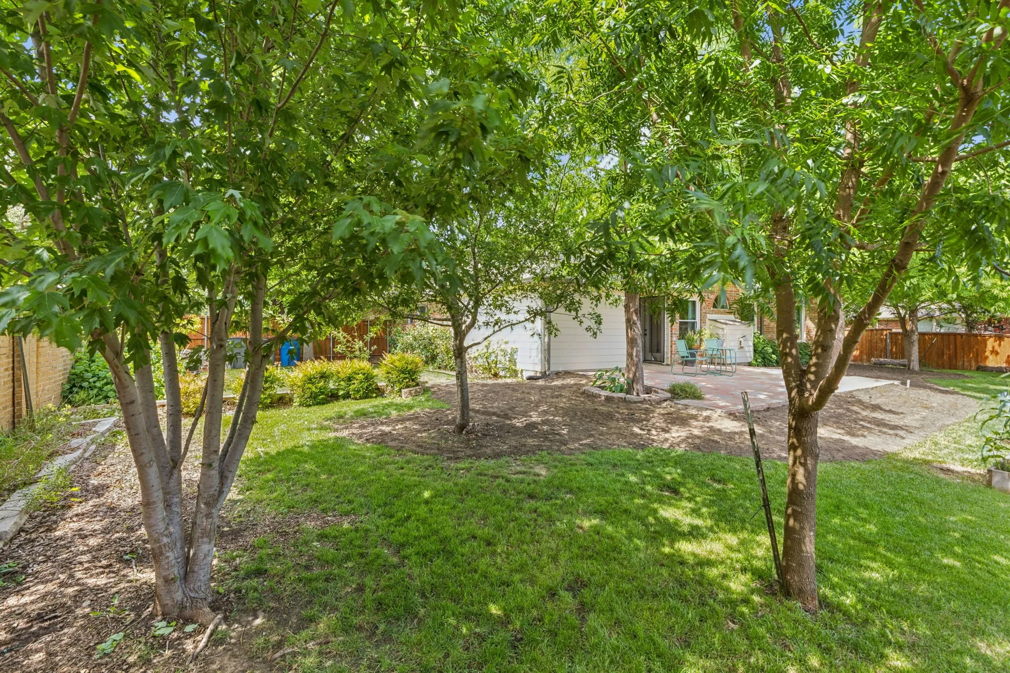 Looking through the lush trees toward the back of
the home. Beautiful!