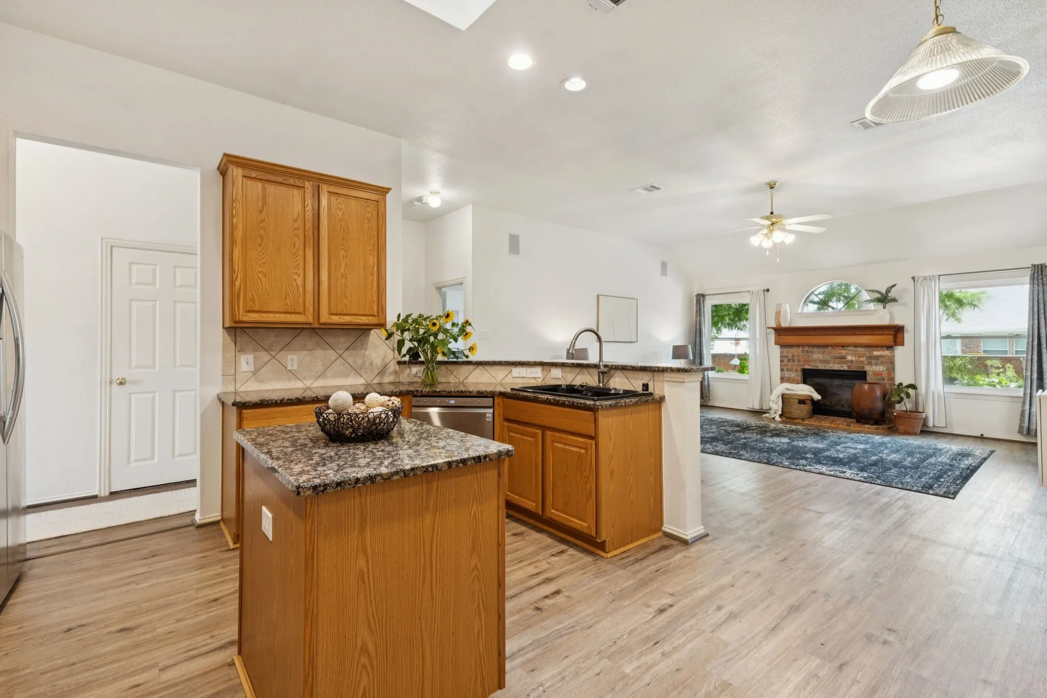 This view of the kitchen shows the open flow into the family room. Great for nights in or gathering with friends and family.