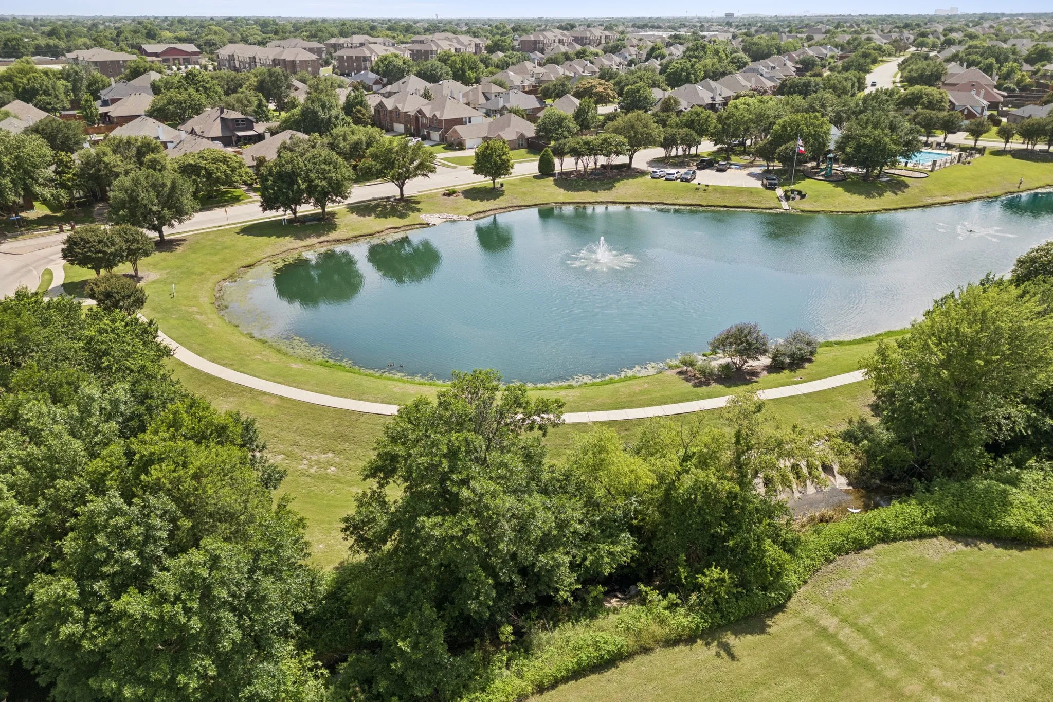 Aerial view of the community lake, walking trails and green spaces.