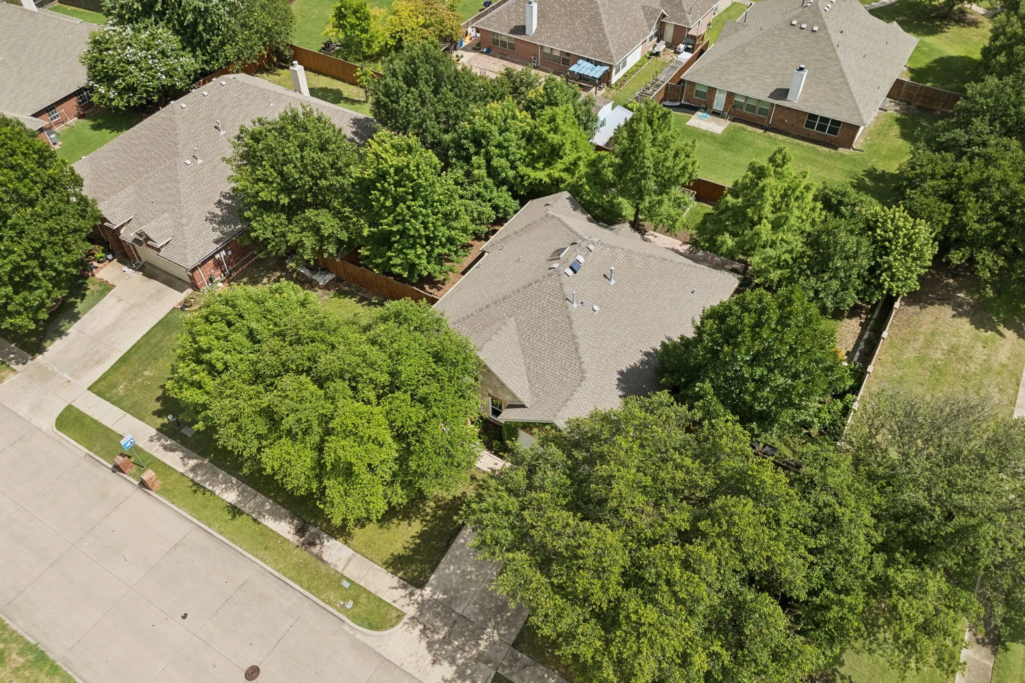 Aerial view of the lot shows the lush greenery all around this wonderful home.