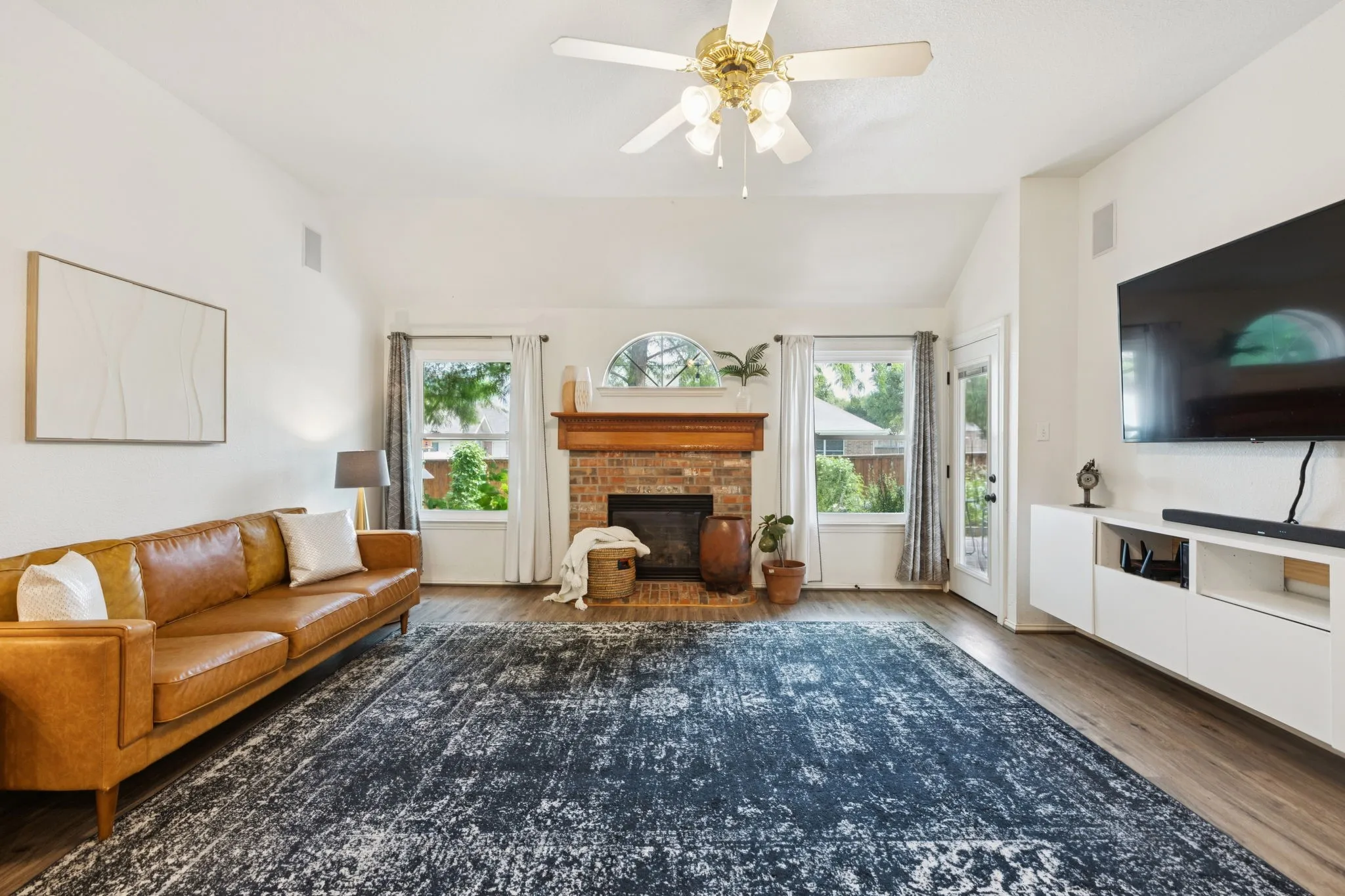 The family room is anchored by a brick fireplace with gas logs. The fireplace is flanked by windows that showcase the backyard. All of the windows in the house are brand new, energy effiecent windows.
