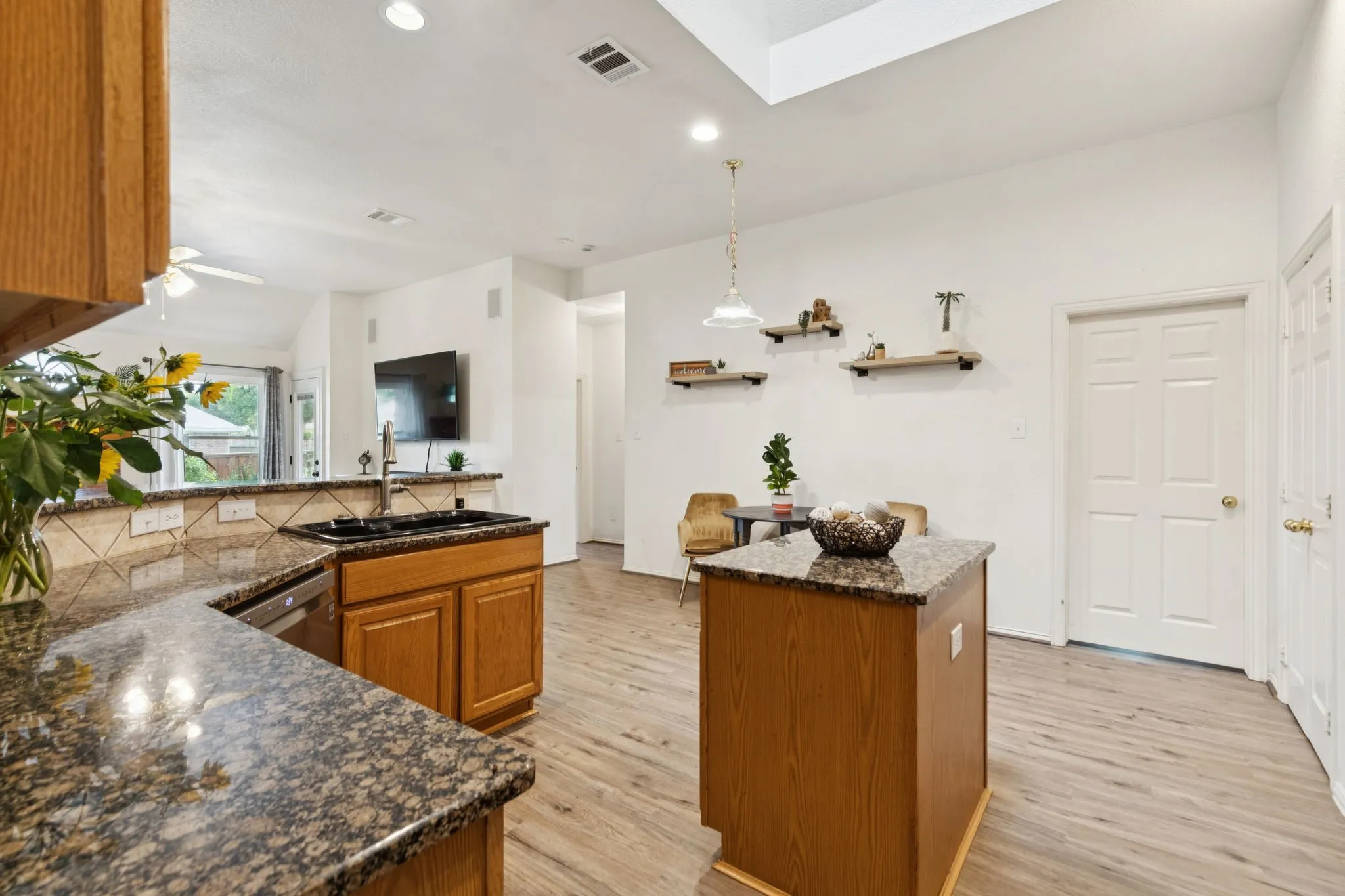 Another view of the kitchen shows the lovely
granite and the open feel of the space. The door shown leads to the laundry room.