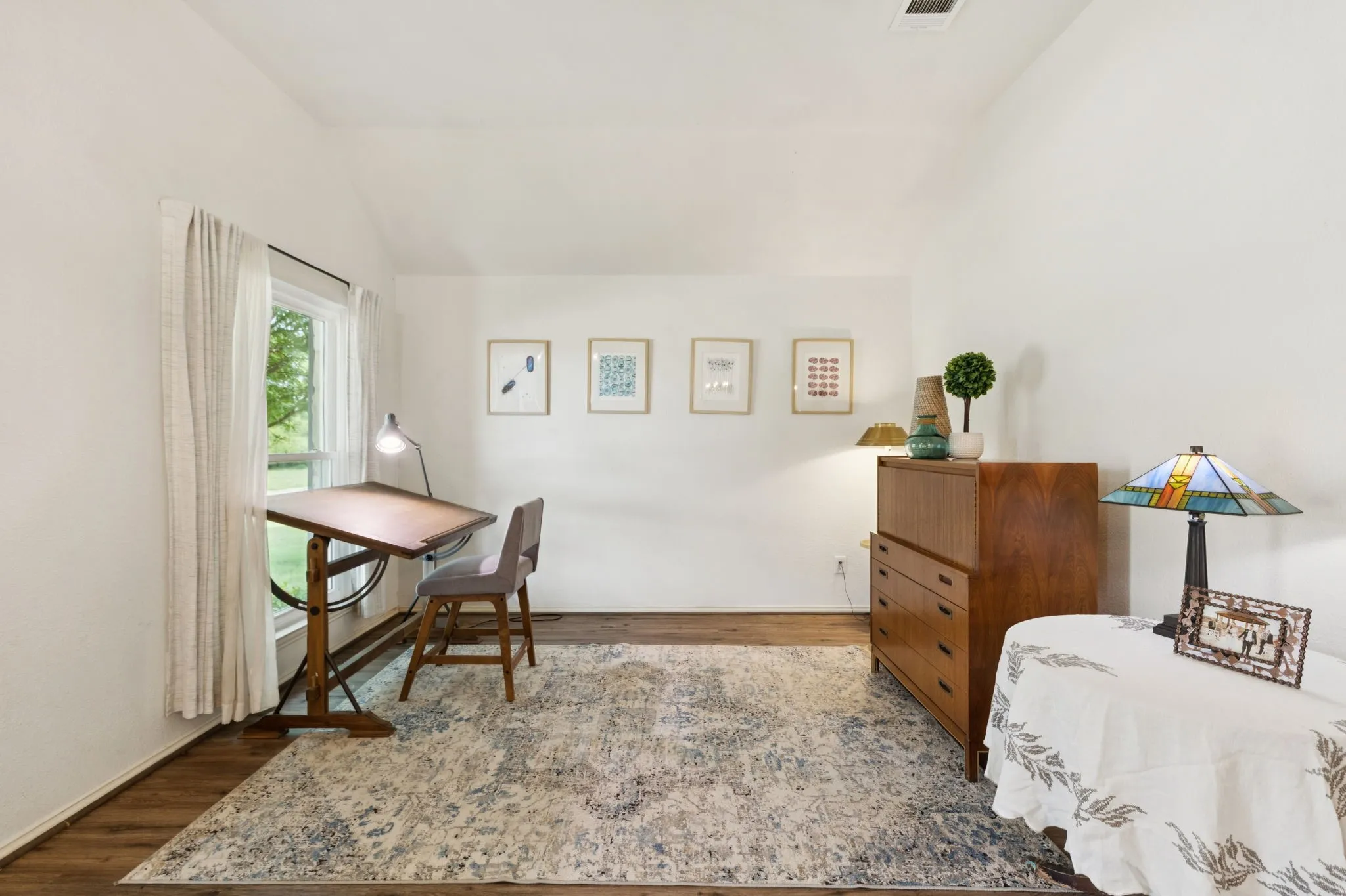 The entry is flanked by the living and dining rooms. The living space has laminate flooring and views of the front yard. The flooring flows through all the common areas of the home.