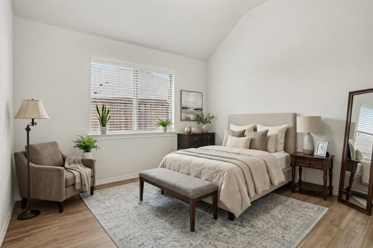 Virtually staged  spacious bedroom featuring vaulted ceilings, light wood-finish flooring, a large window, and light-colored walls