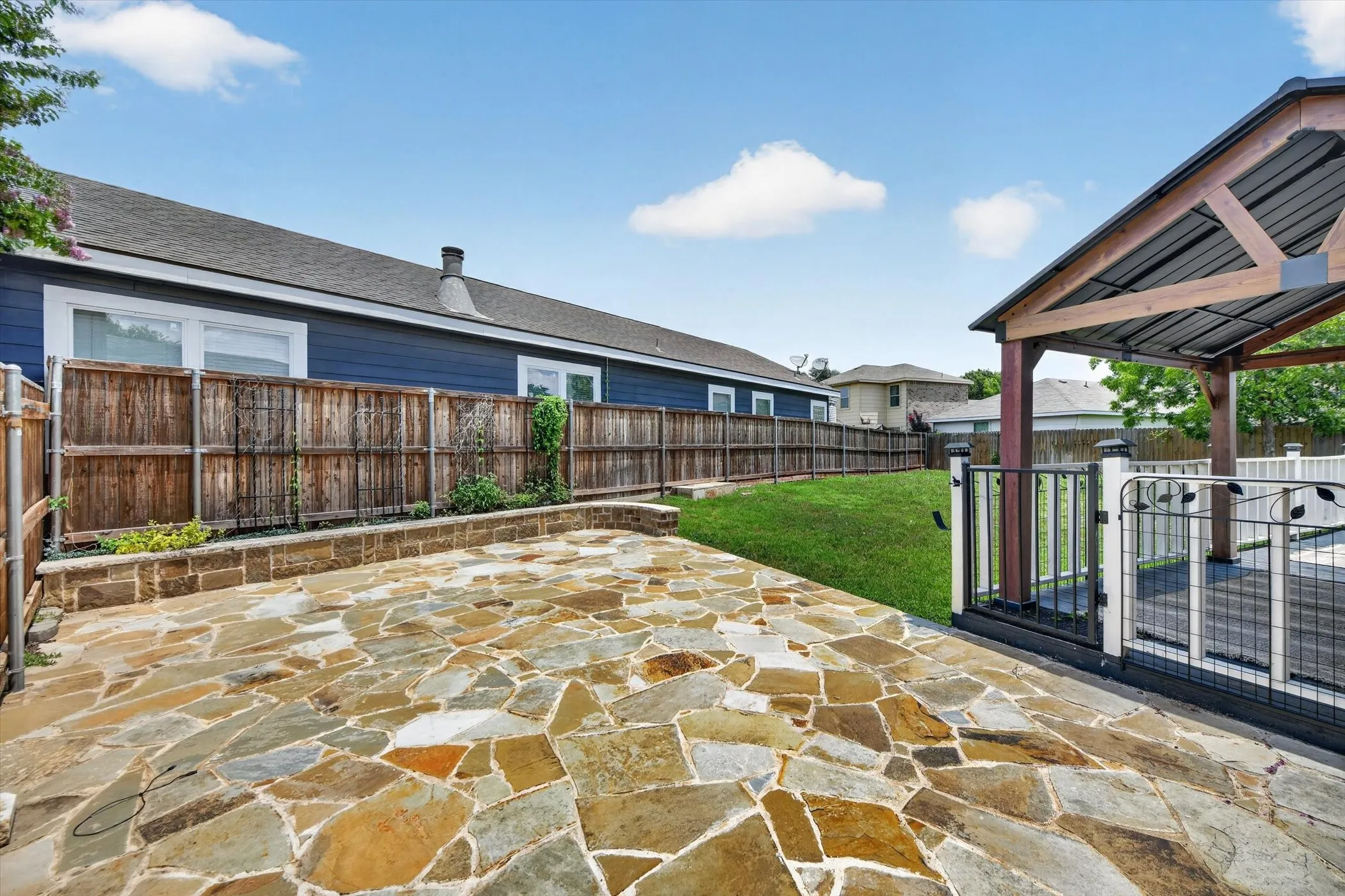 Stone paver patio with a raised stone planter