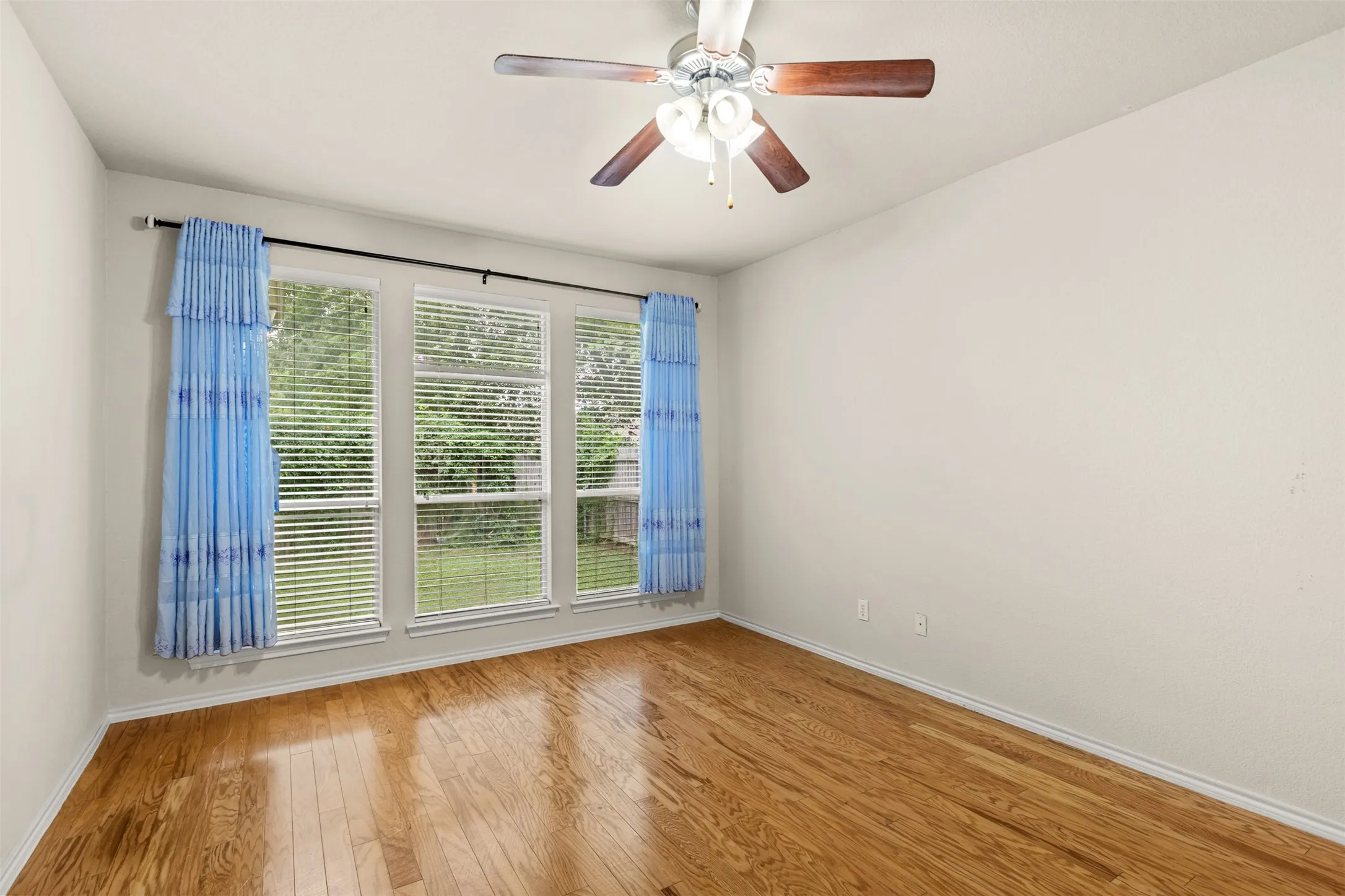 Room featuring wood-finish flooring and light-toned walls