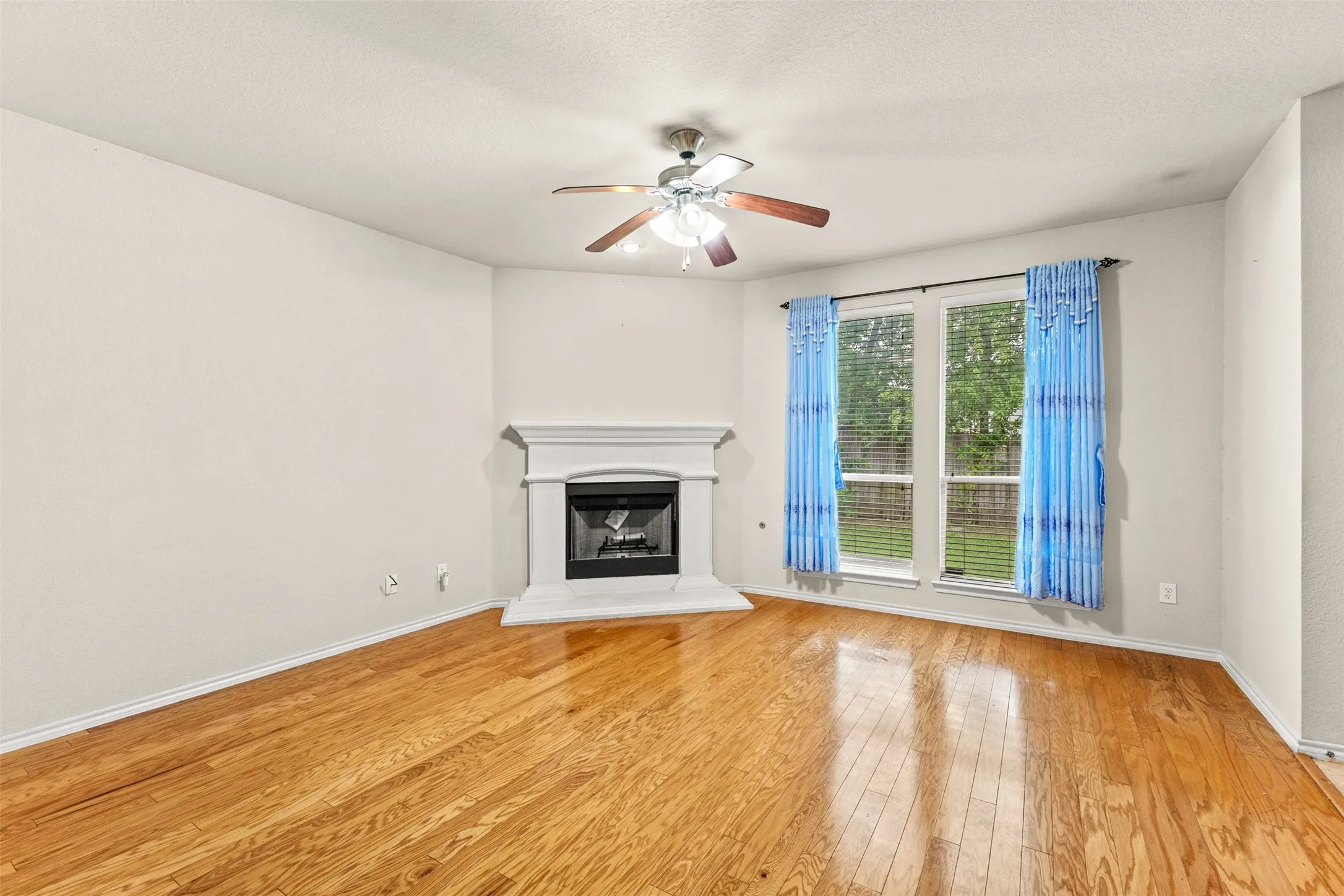 Warm wood-finish flooring complements the neutral wall color