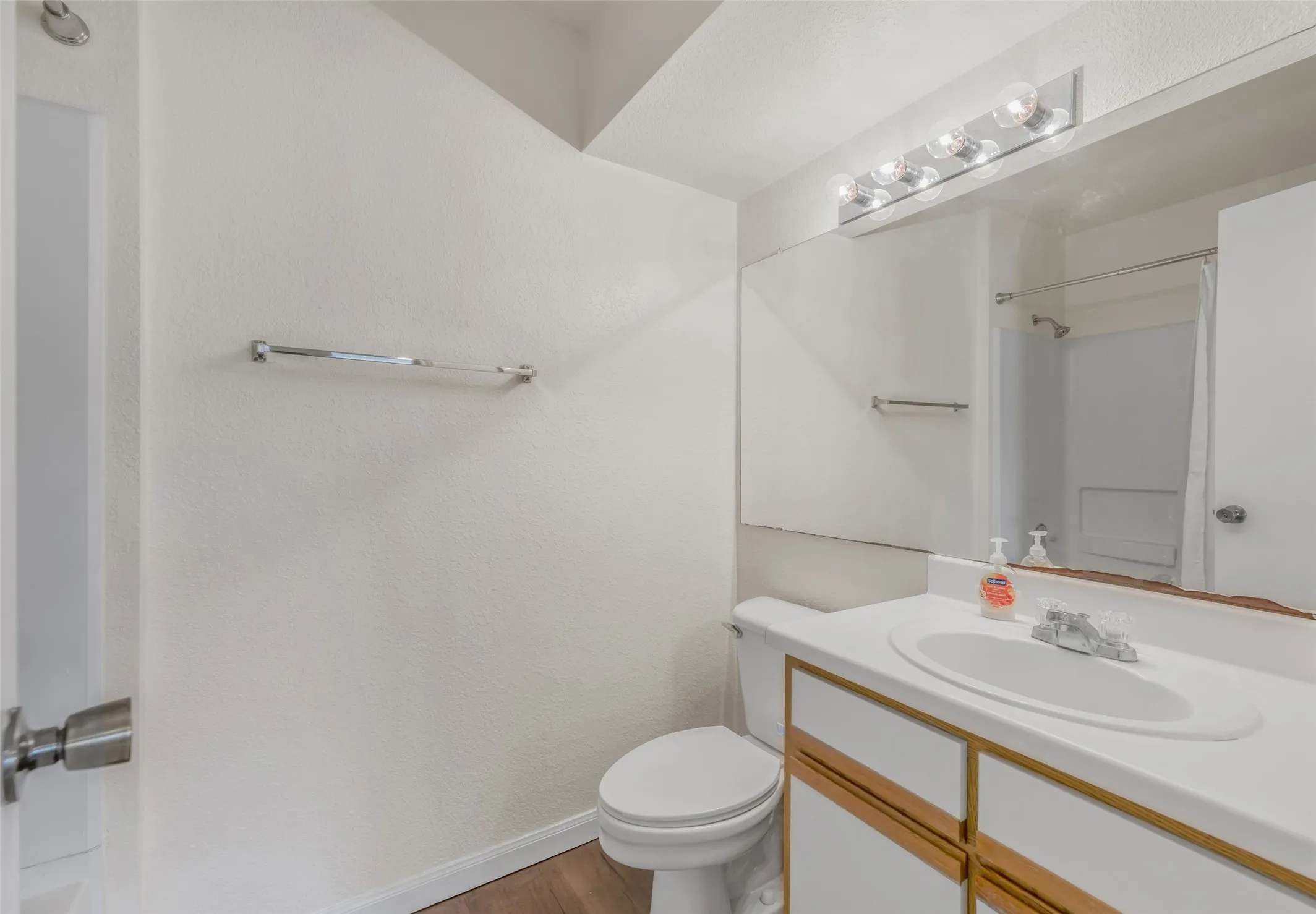 Bathroom featuring a vanity with wood-finish cabinetry, a white countertop, and an integrated sink