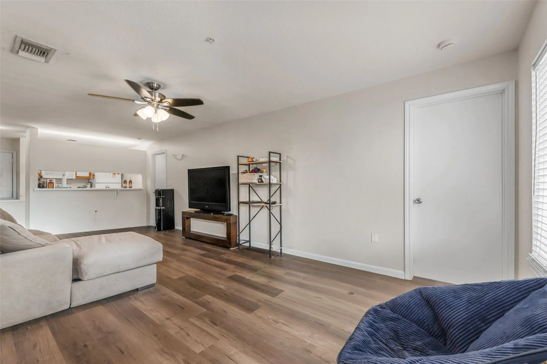 Living area with a look towards kitchen breakfast bar