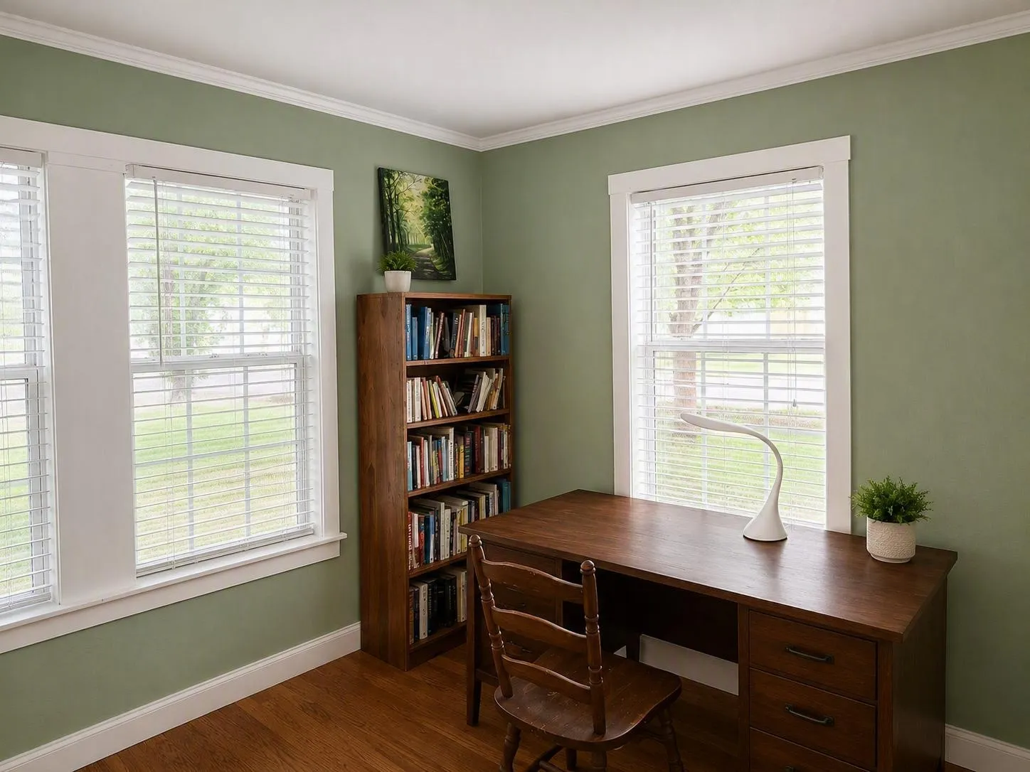 Room featuring hardwood flooring, white crown molding, and two large windows with horizontal blinds