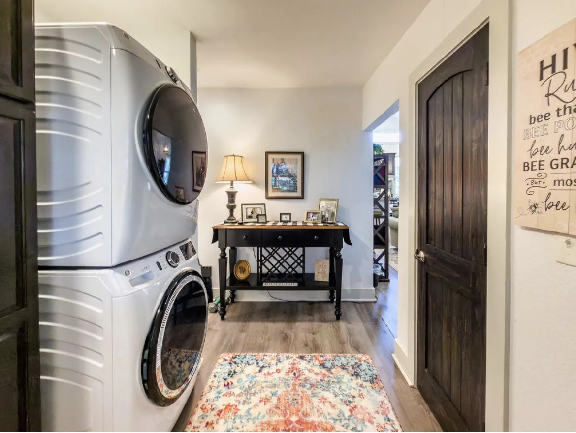 Compact laundry area featuring stacked front-load appliances