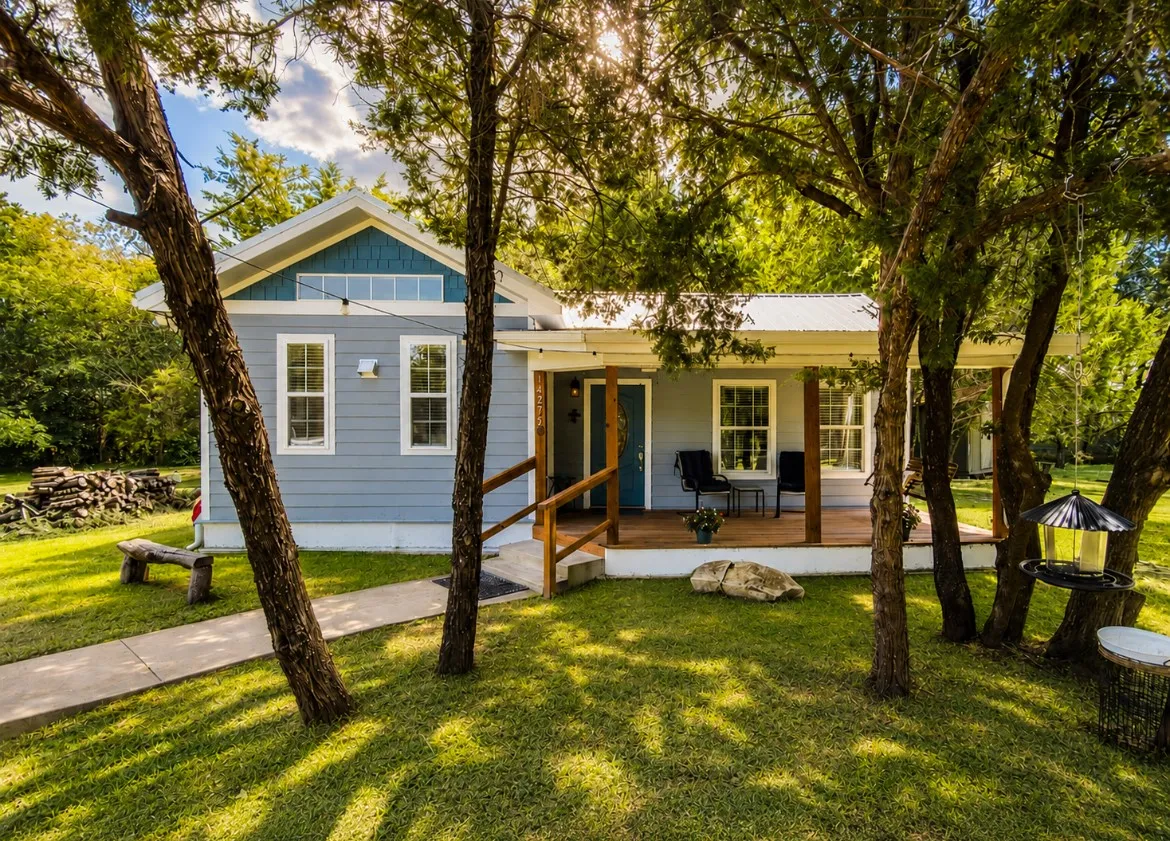 Light blue siding exterior with a metal roof and a prominent front porch