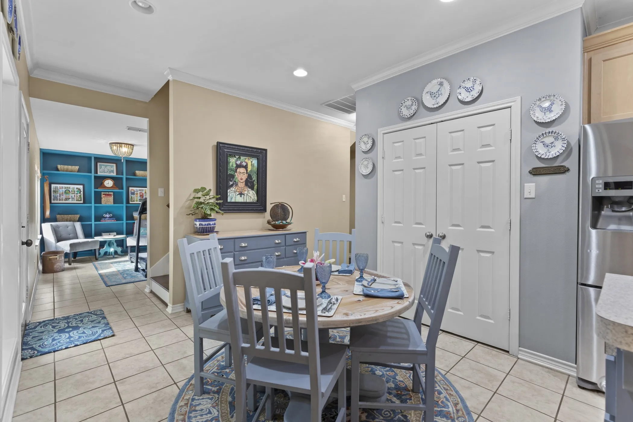 Dining area with tile flooring and crown molding