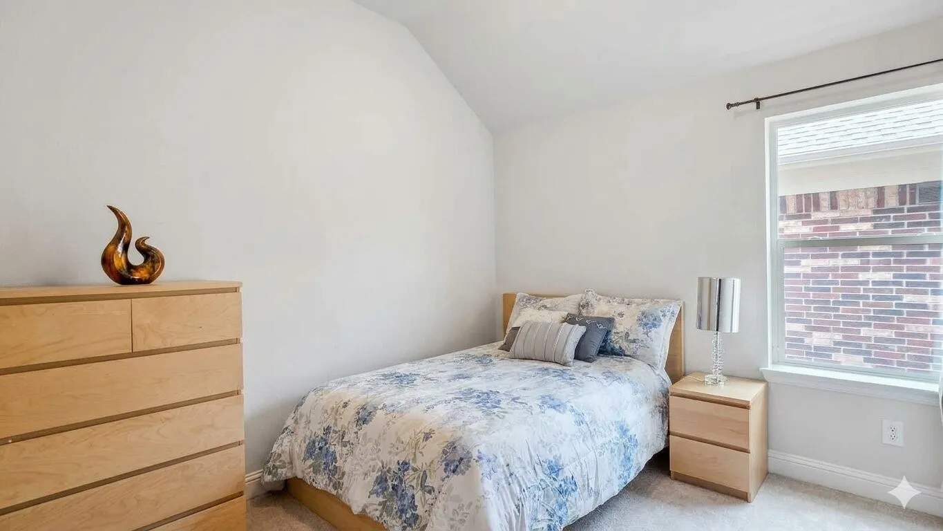 Bedroom featuring a vaulted ceiling and neutral wall color