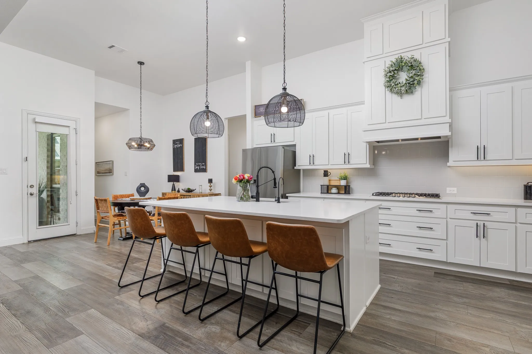 Bright kitchen featuring an expansive central island with seating