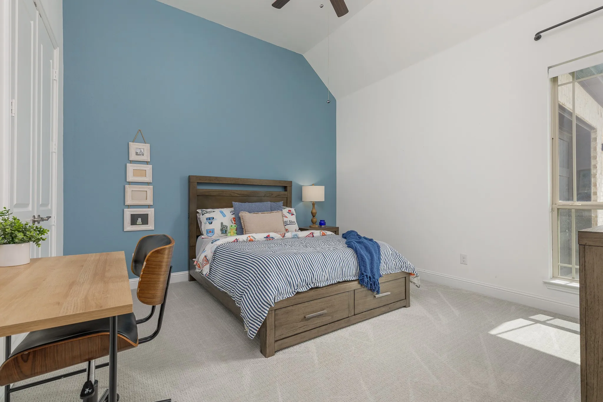 Bedroom featuring a vaulted ceiling and light-colored carpet flooring