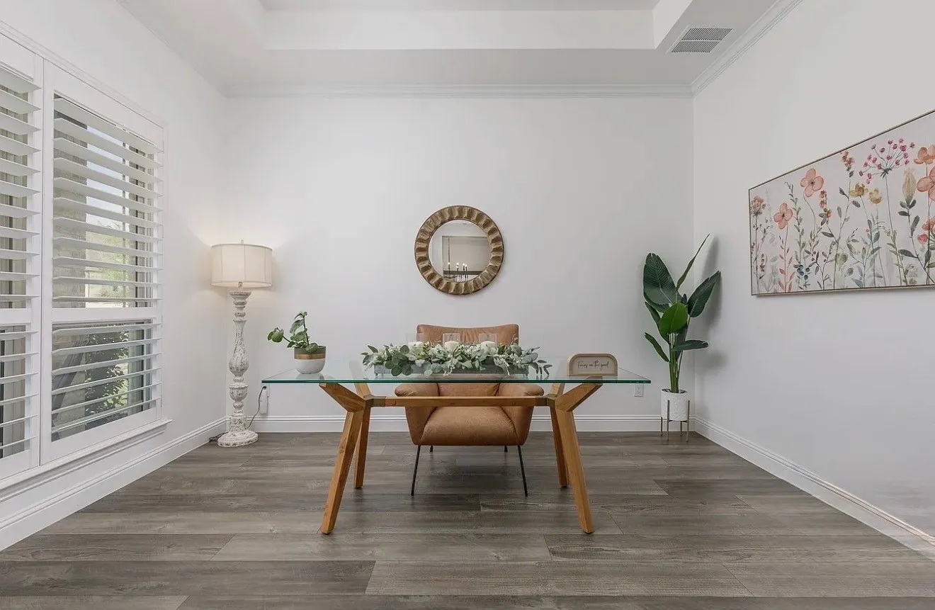 Recessed ceiling, wood-finish flooring, white plantation shutters, white crown molding, and white baseboards