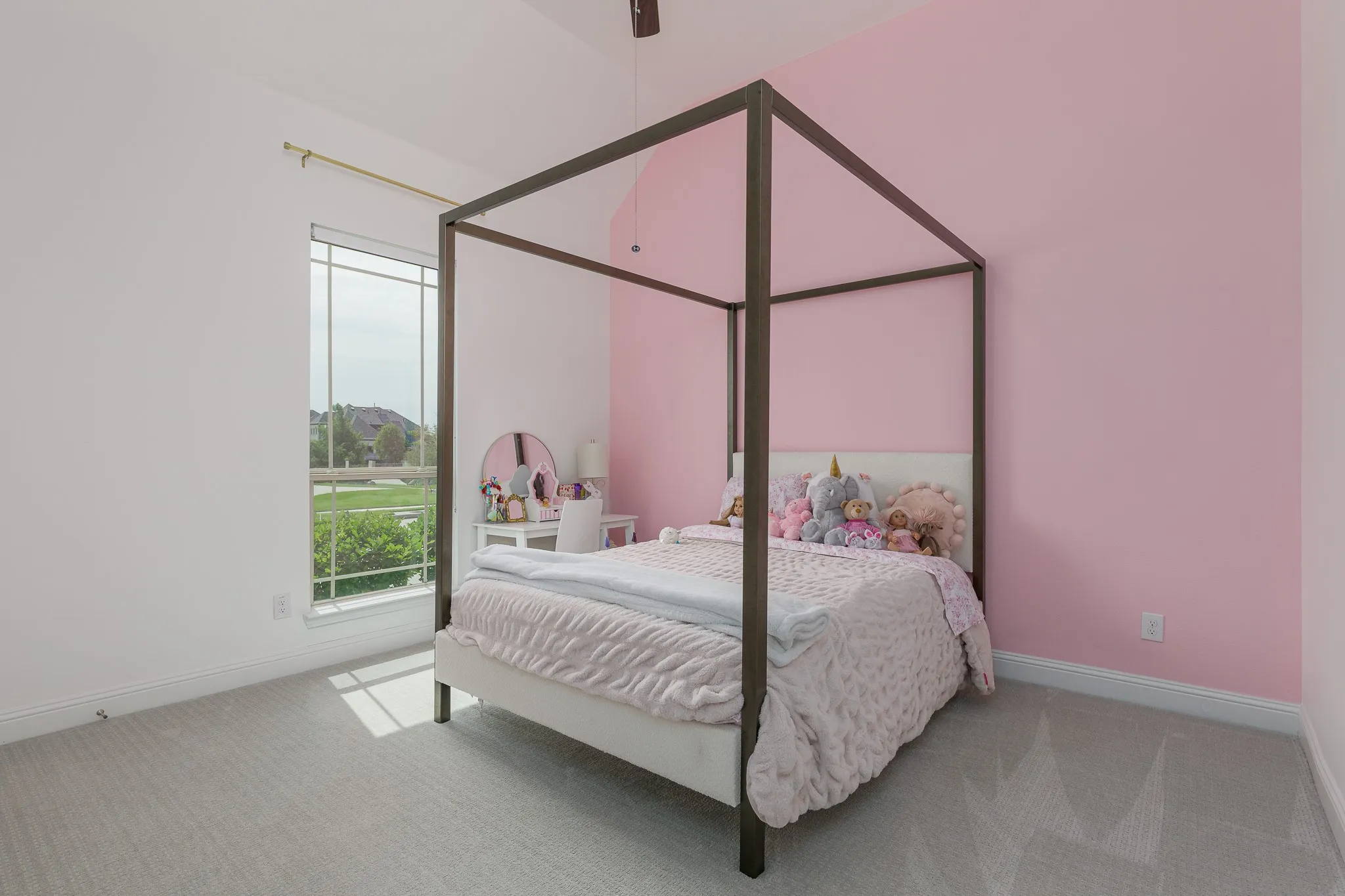 Spacious room featuring a large window, light gray carpeting, and a unique two-tone wall treatment