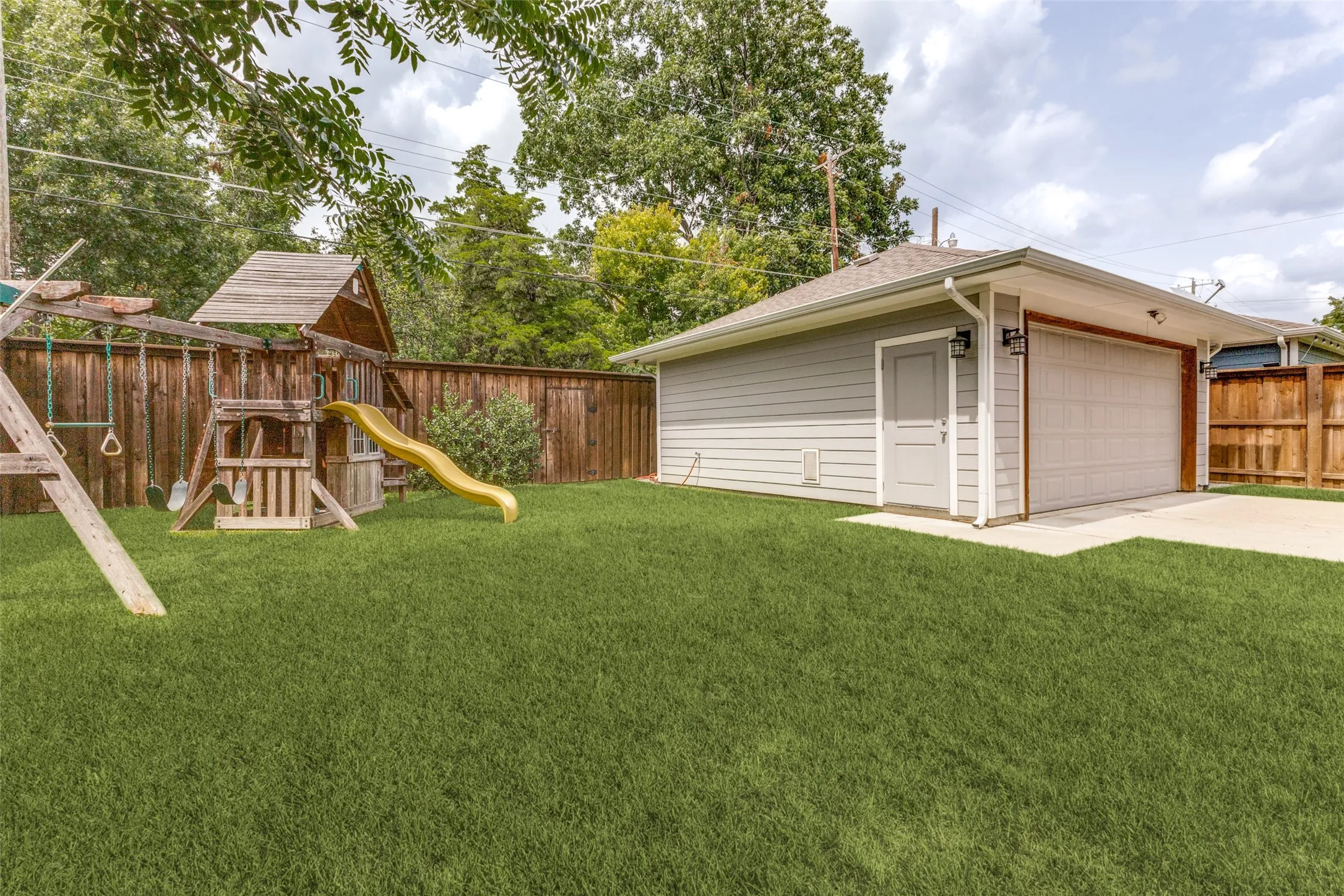 large yard with gate to alley trash (unique to the neighborhood)