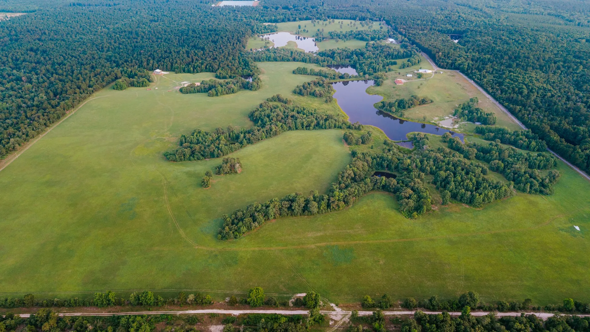 Expansive parcel featuring open fields, wooded sections, and multiple ponds