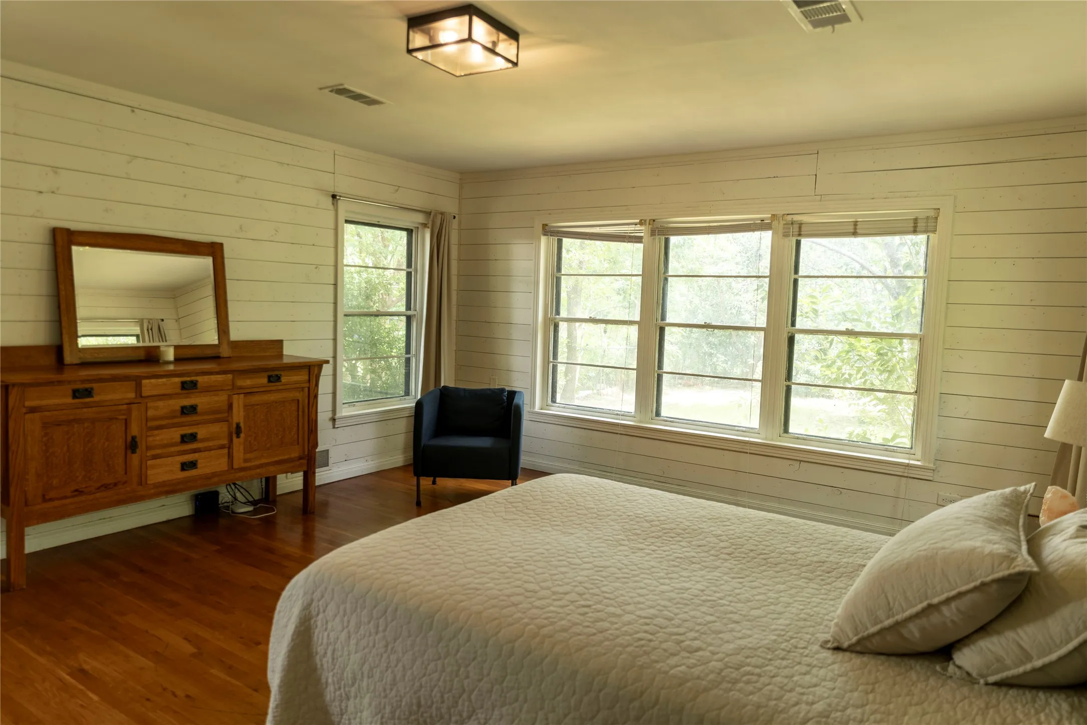 Room featuring wood-finish flooring and horizontal plank walls