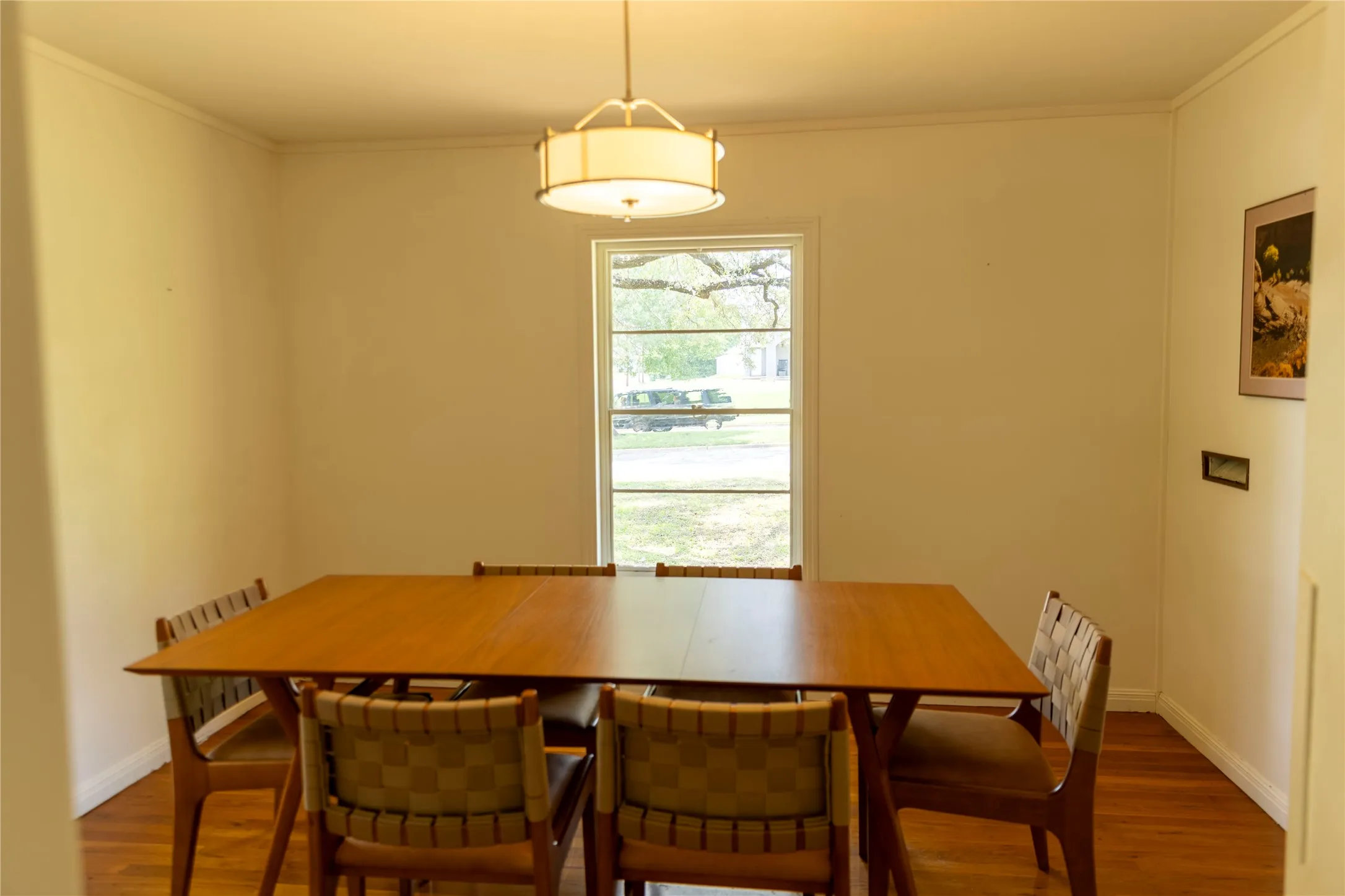 Hardwood flooring throughout the room, complemented by a white trim package