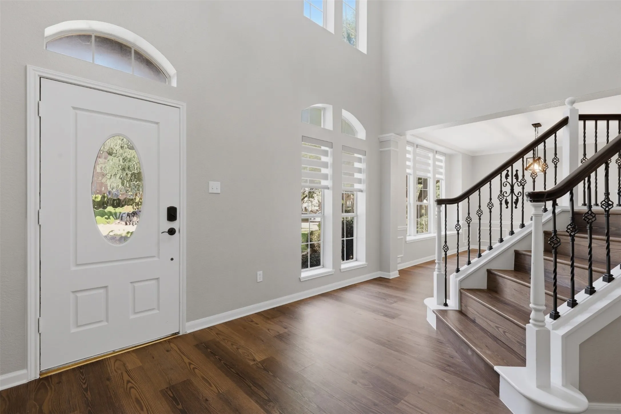 Grand entry featuring a two-story ceiling and wood-finish flooring