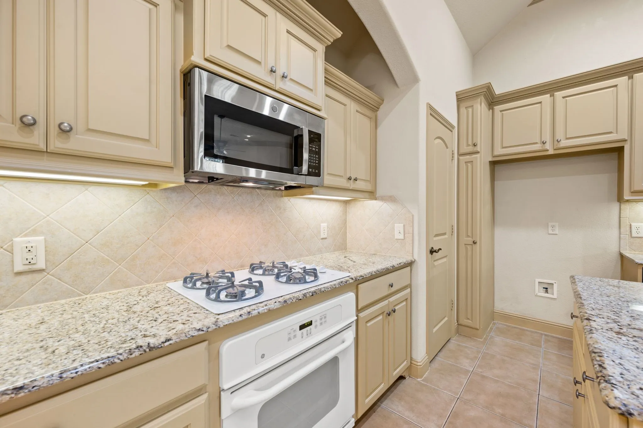 Gas Cooktop, Oven and Stainless Steel Microwave.