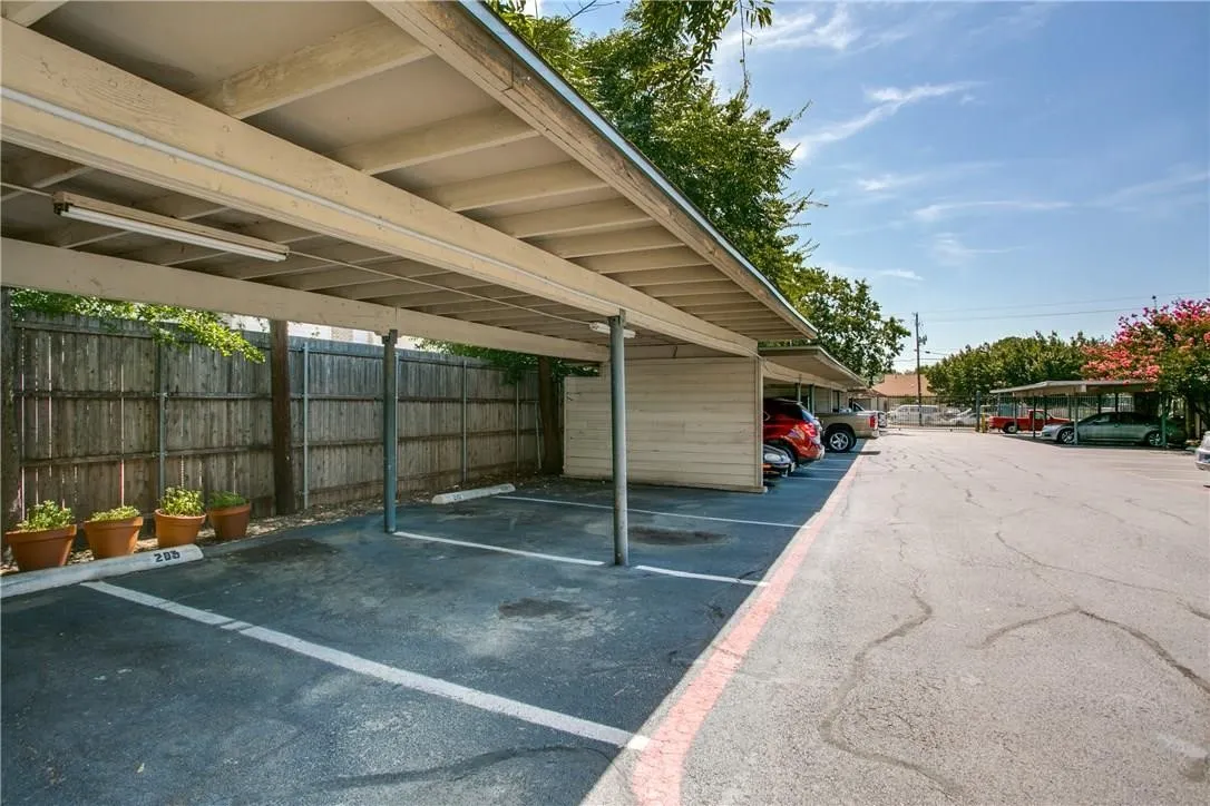 View of parking featuring a carport