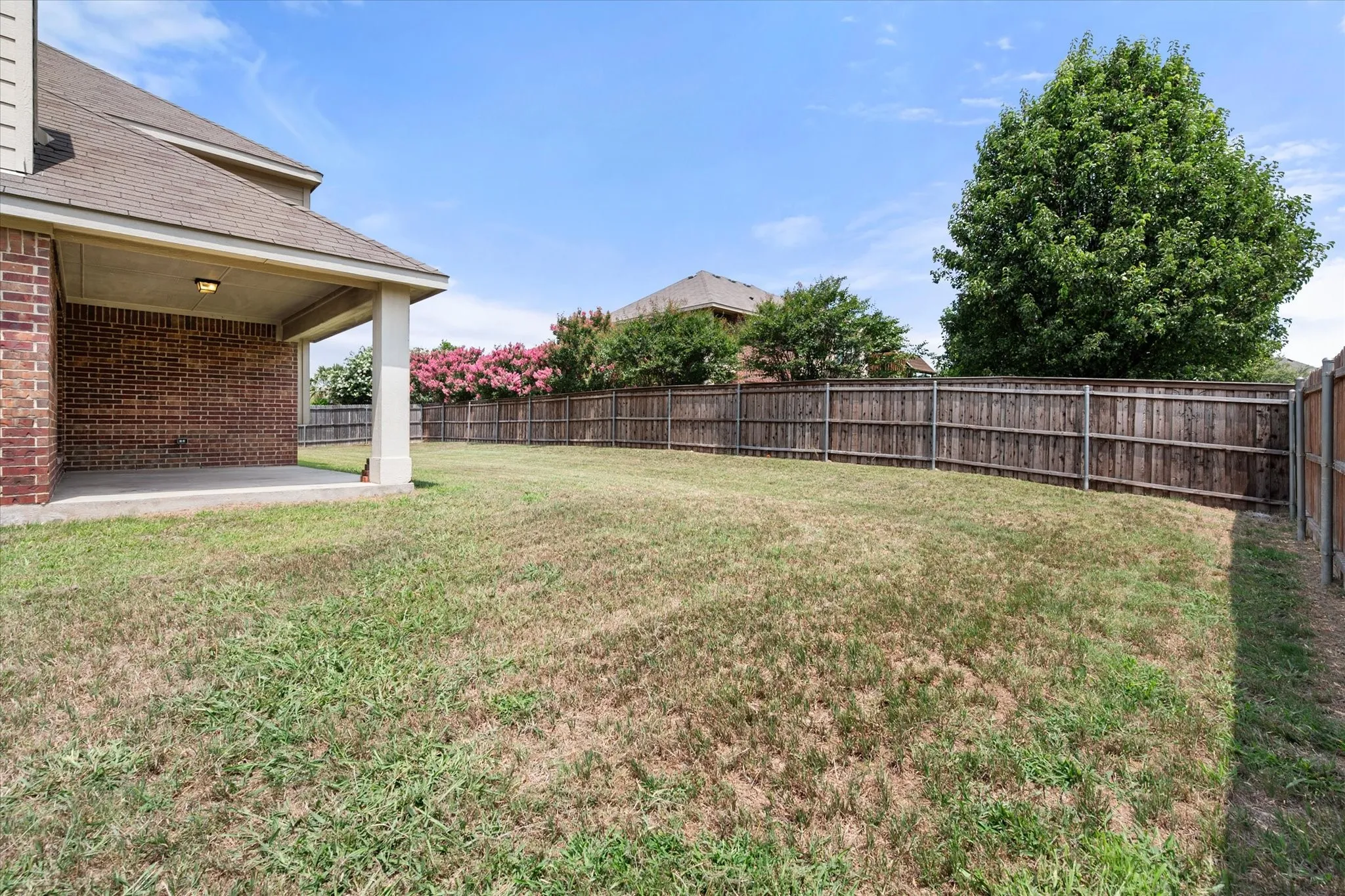 Expansive backyard featuring a covered patio