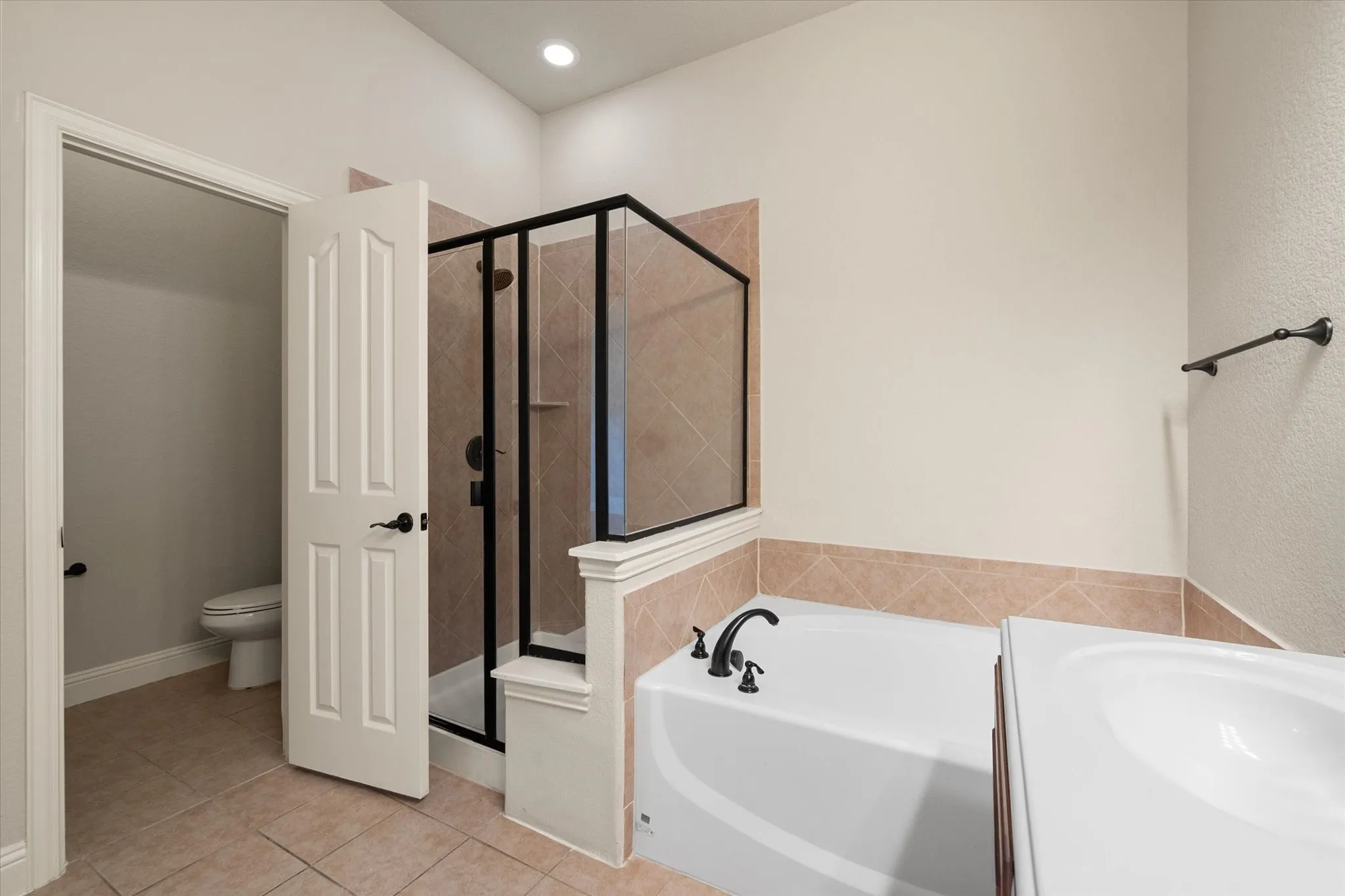 Bathroom featuring a built-in tub & separate shower