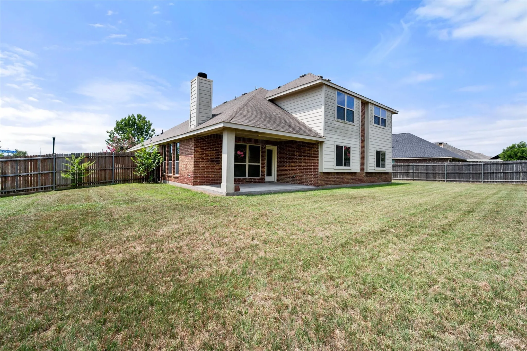 Spacious backyard featuring a covered patio