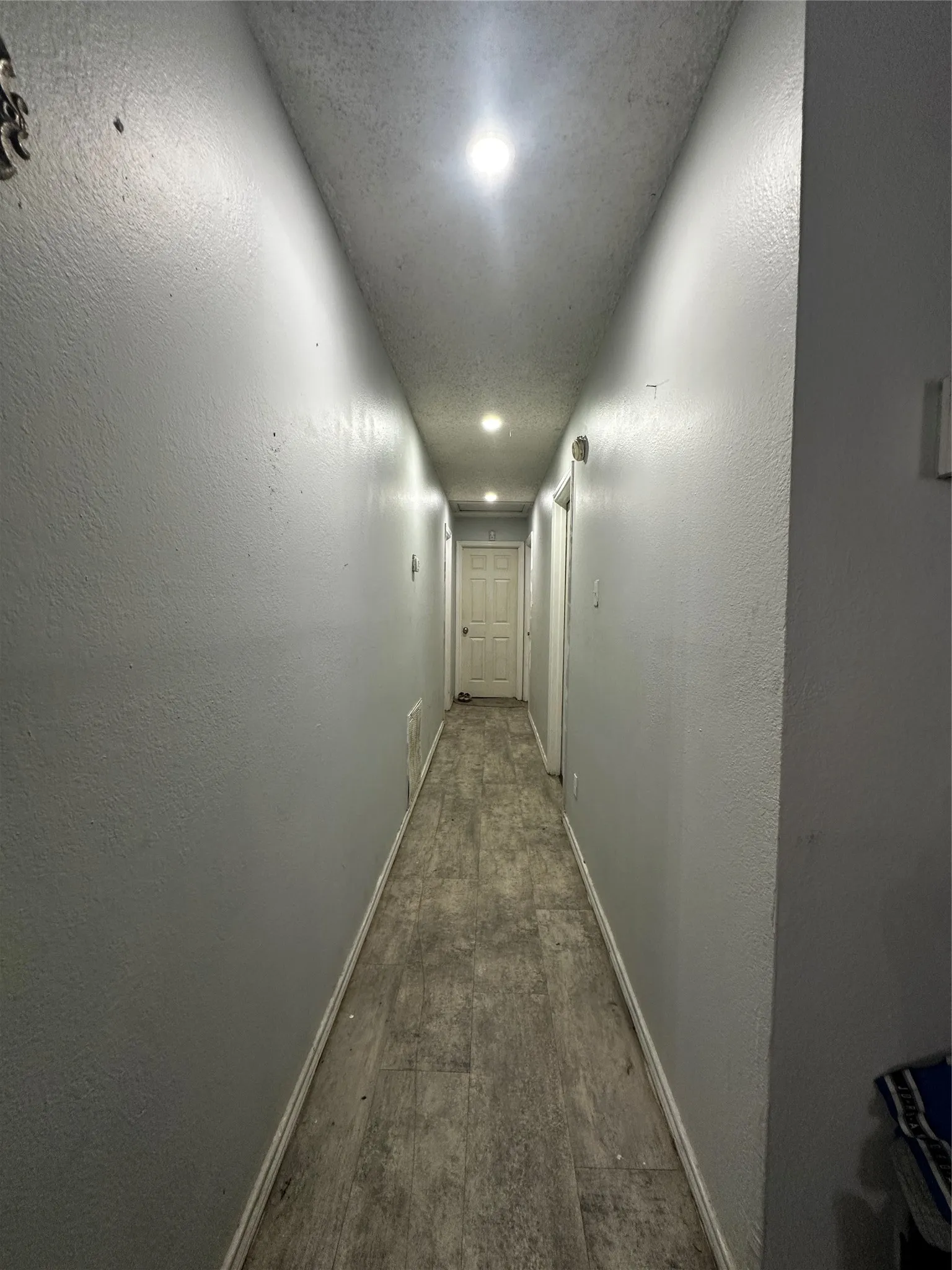 Hallway featuring light gray walls, recessed lighting, and wood-finish flooring
