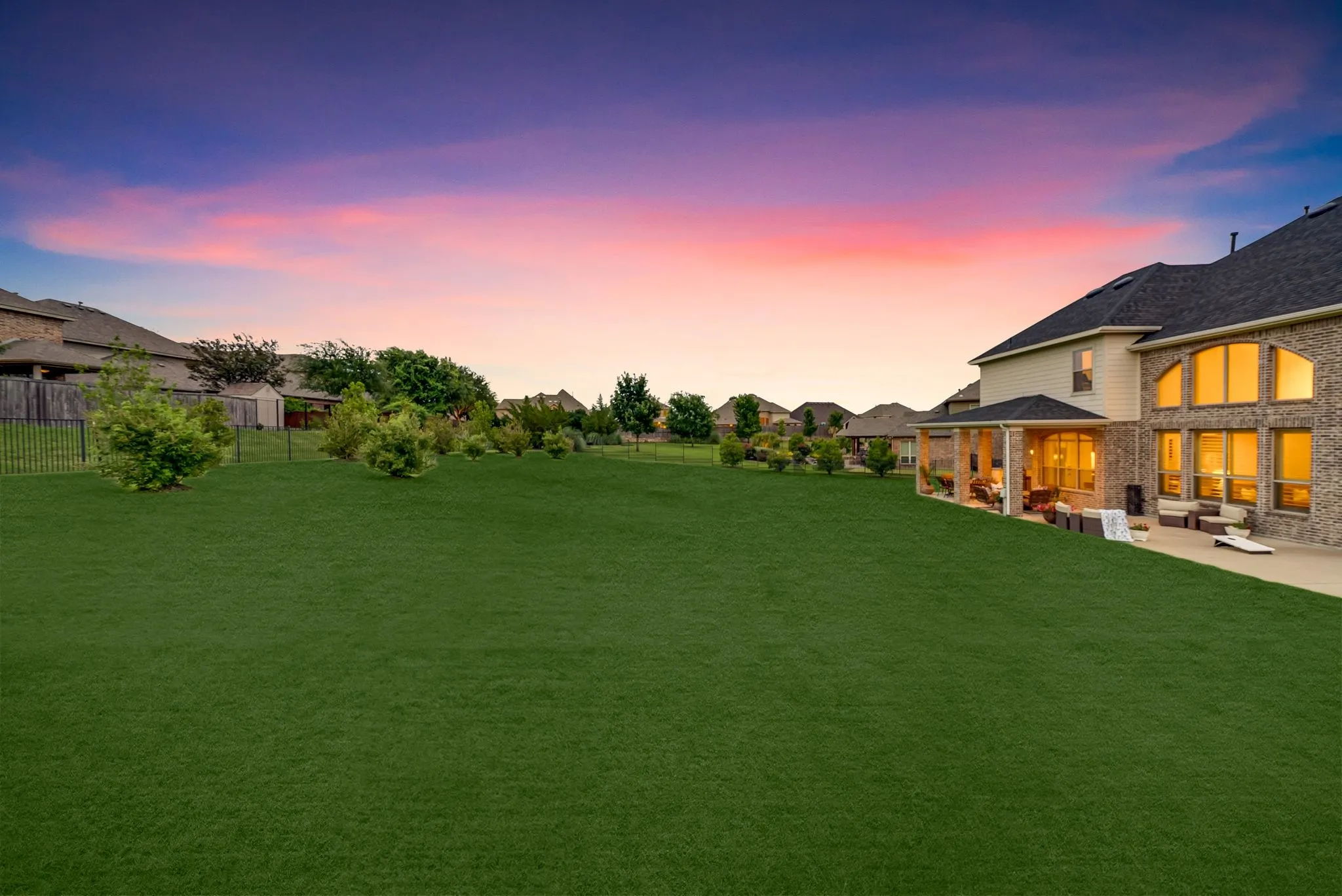 Expansive green lawn with mature landscaping