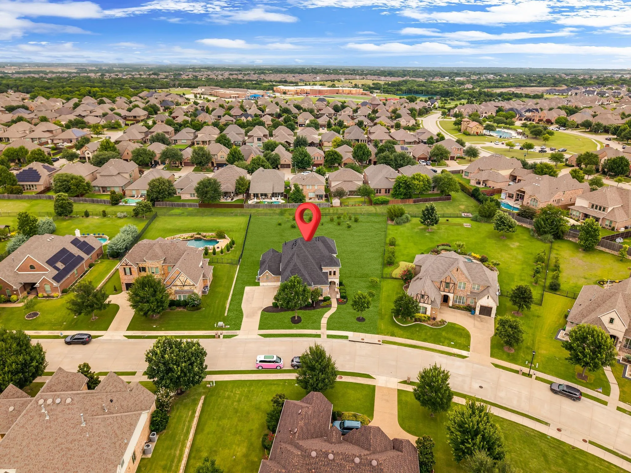 Suburban neighborhood featuring manicured lawns and mature trees