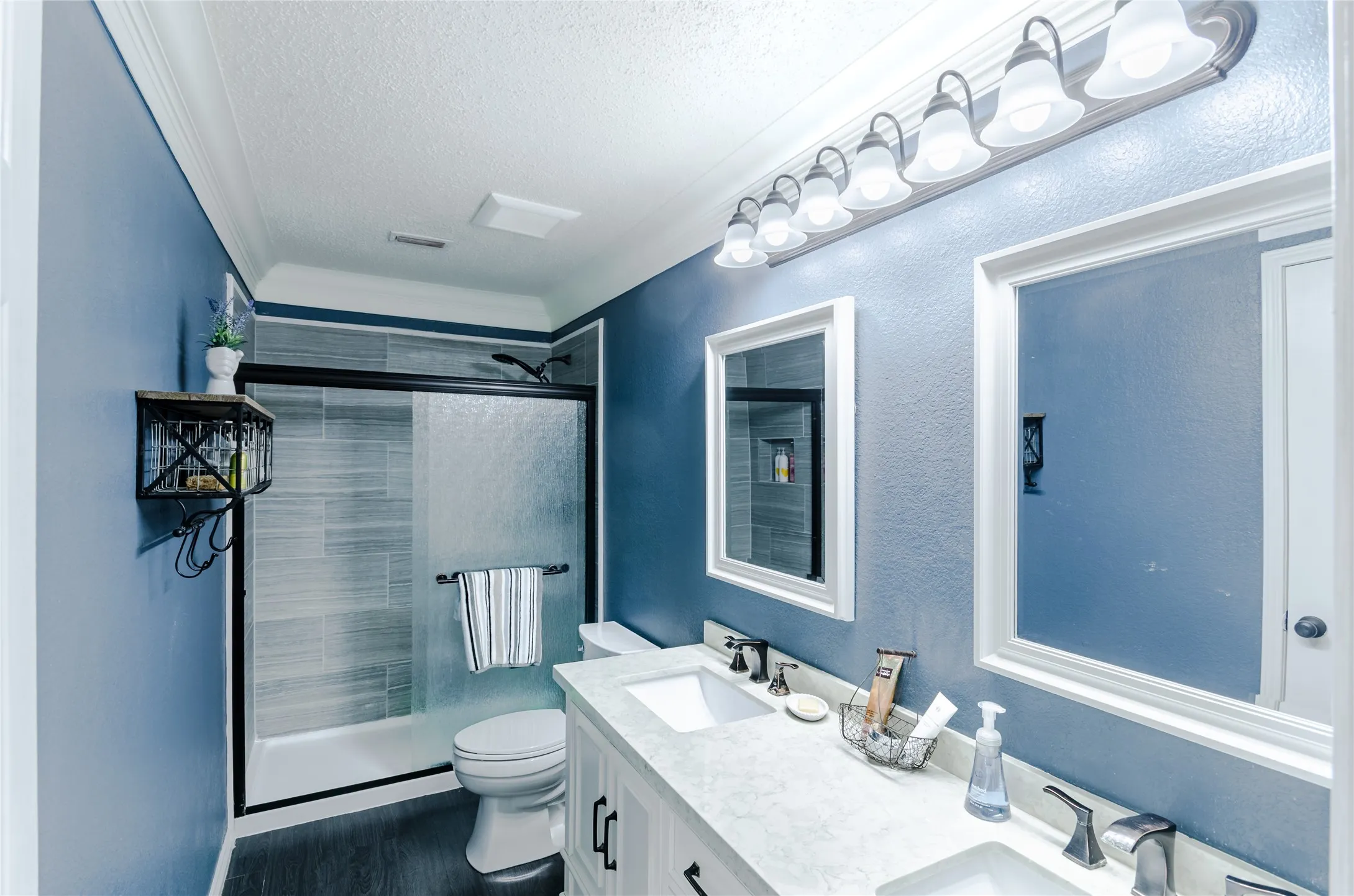 Bathroom featuring a double vanity with stone countertops and undermount sinks