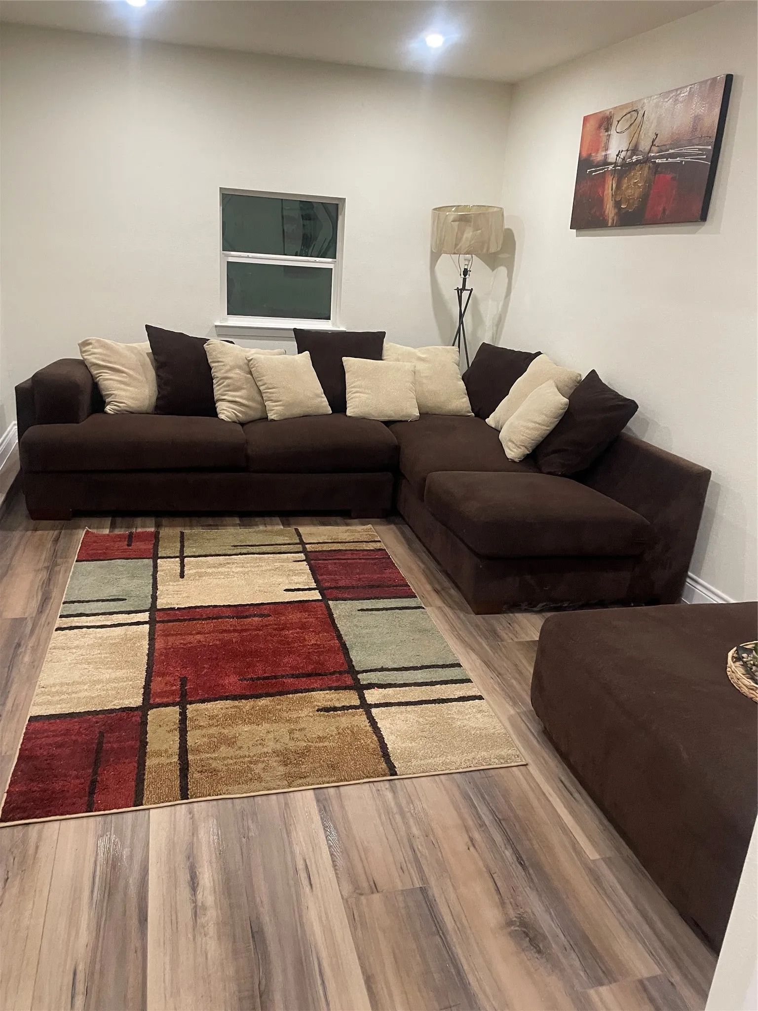 Neutral wall paint finishes and recessed lighting complement wood-finish flooring
