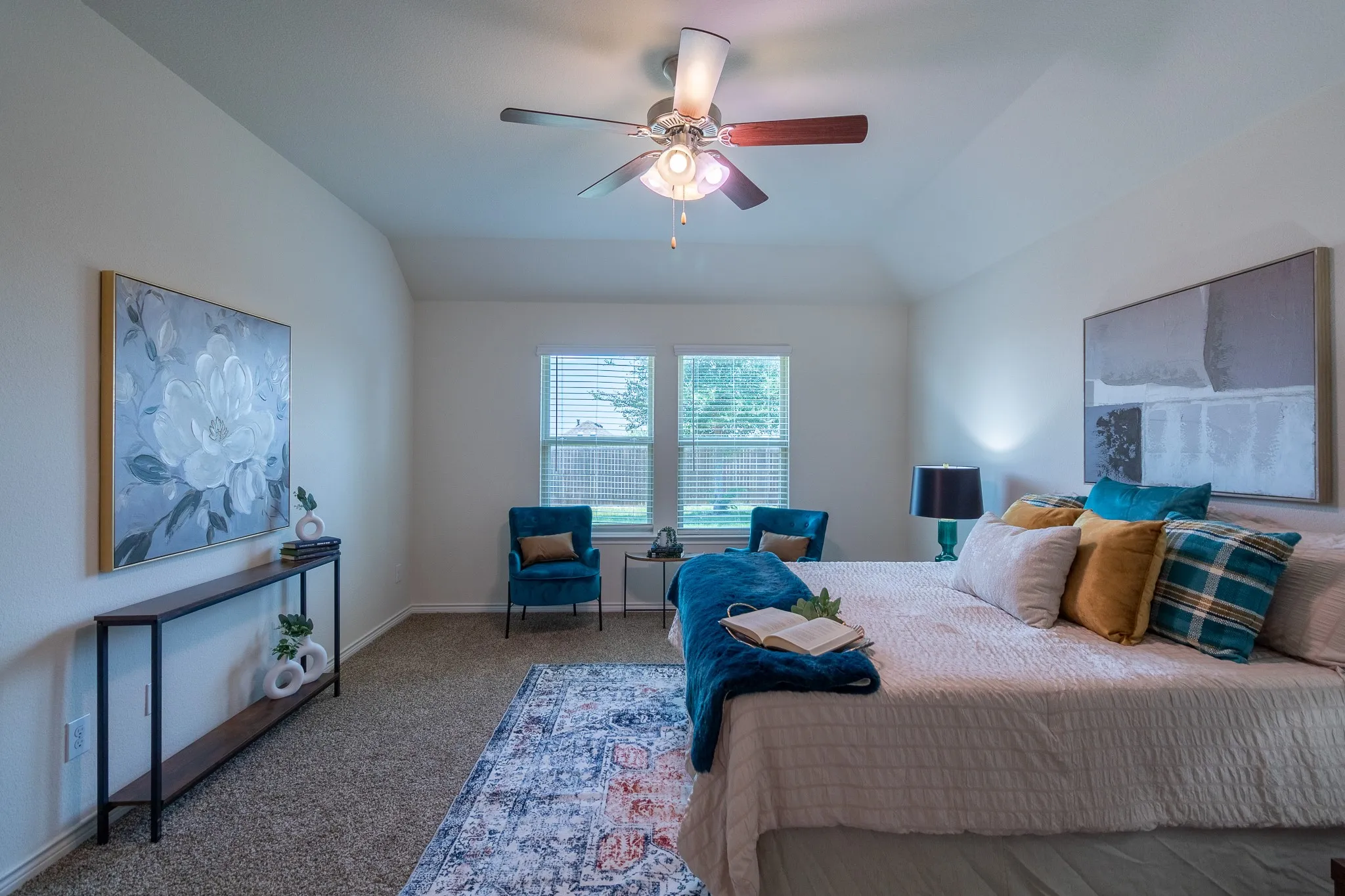 Spacious room with vaulted ceilings and textured carpeting